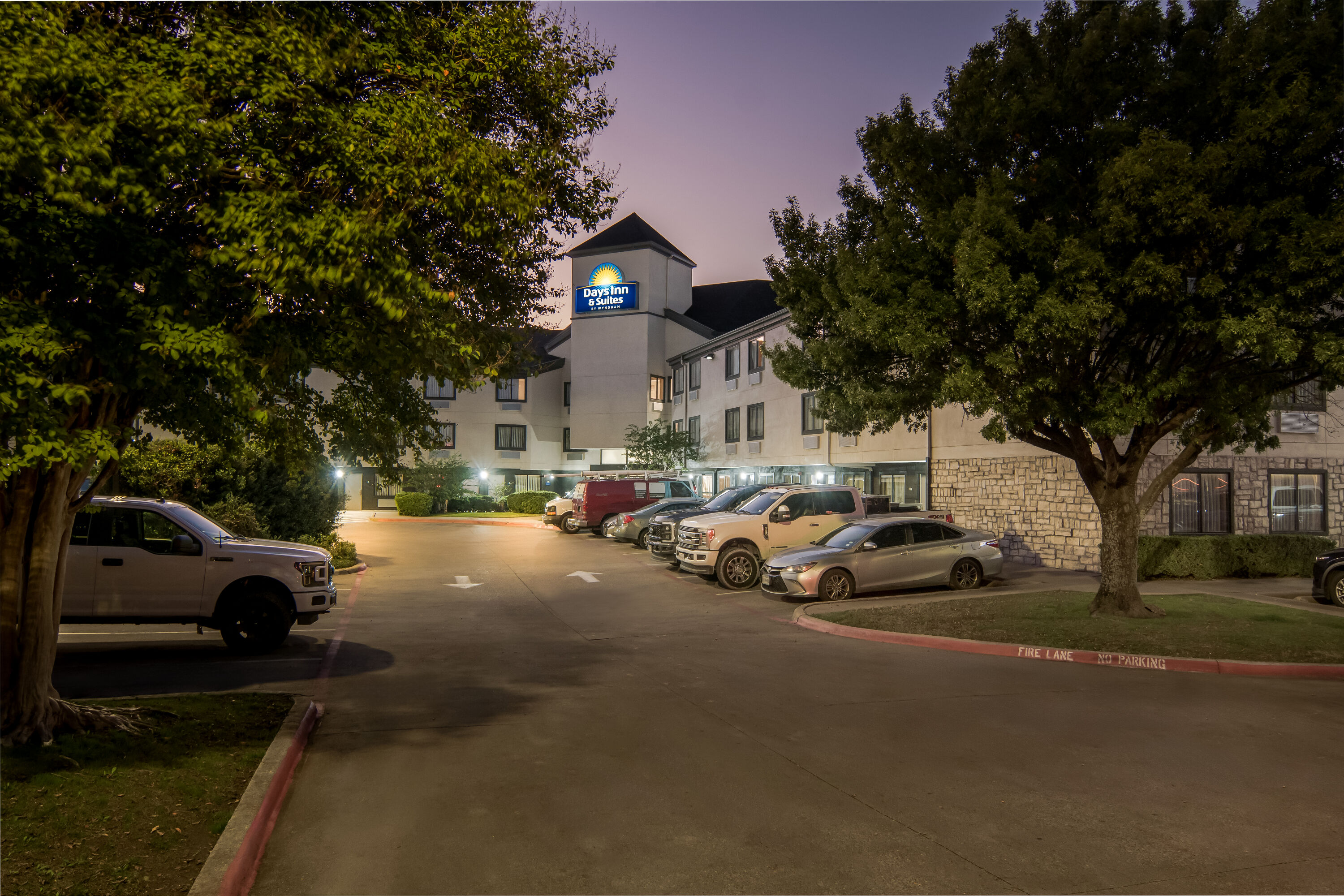 Exterior Night Image of Days Inn & Suites by Wyndham DeSoto hotel in DeSoto, Texas