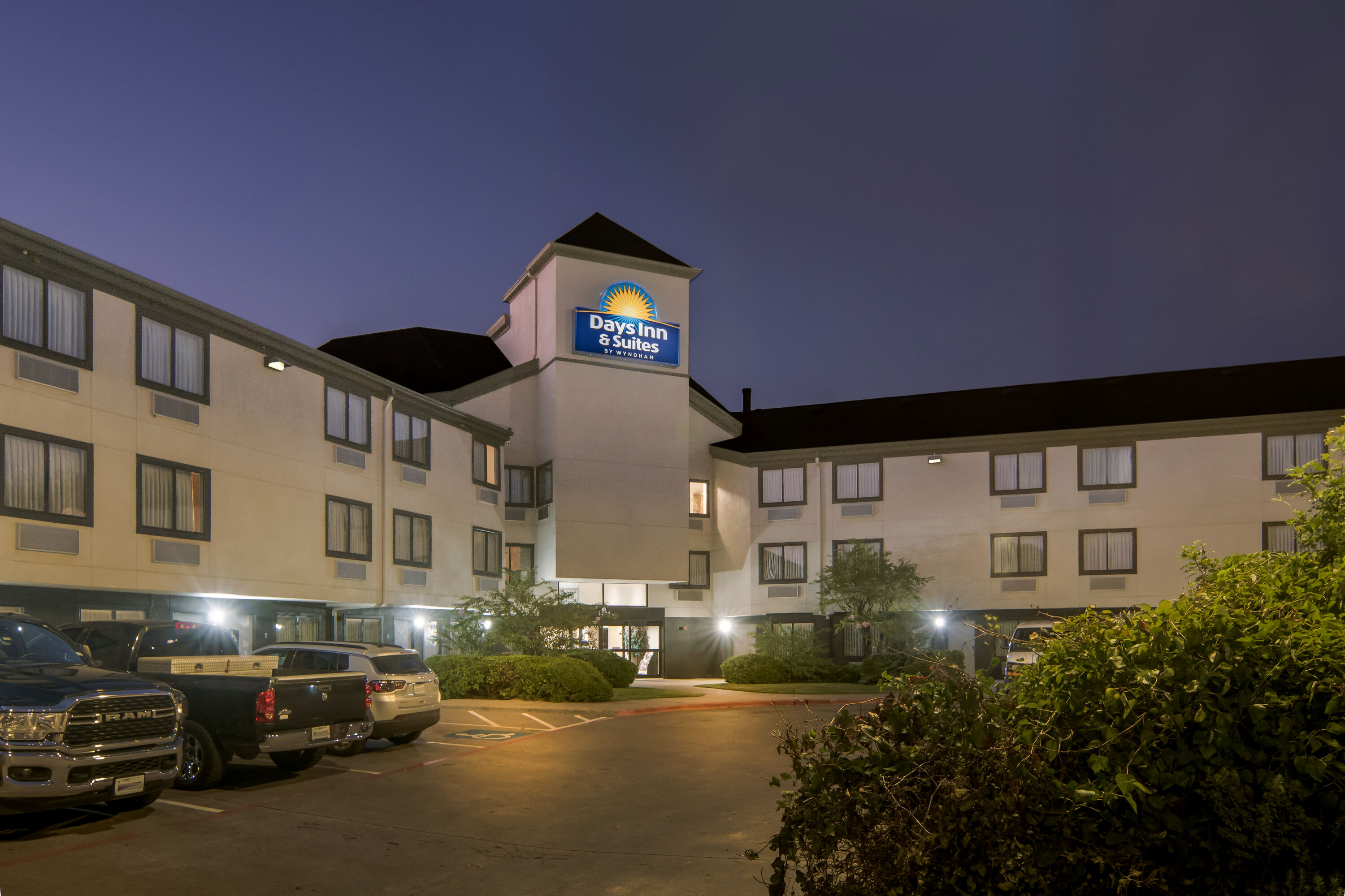Exterior Night Image of Days Inn & Suites by Wyndham DeSoto hotel in DeSoto, Texas