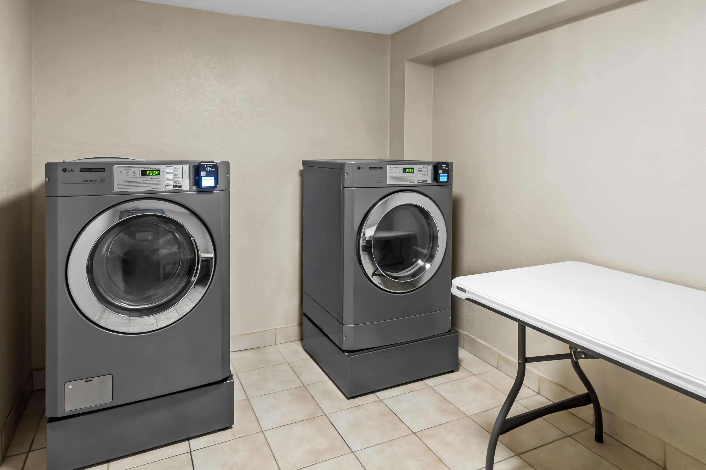 Laundry facilities at Days Inn & Suites by Wyndham DeSoto in DeSoto, Texas