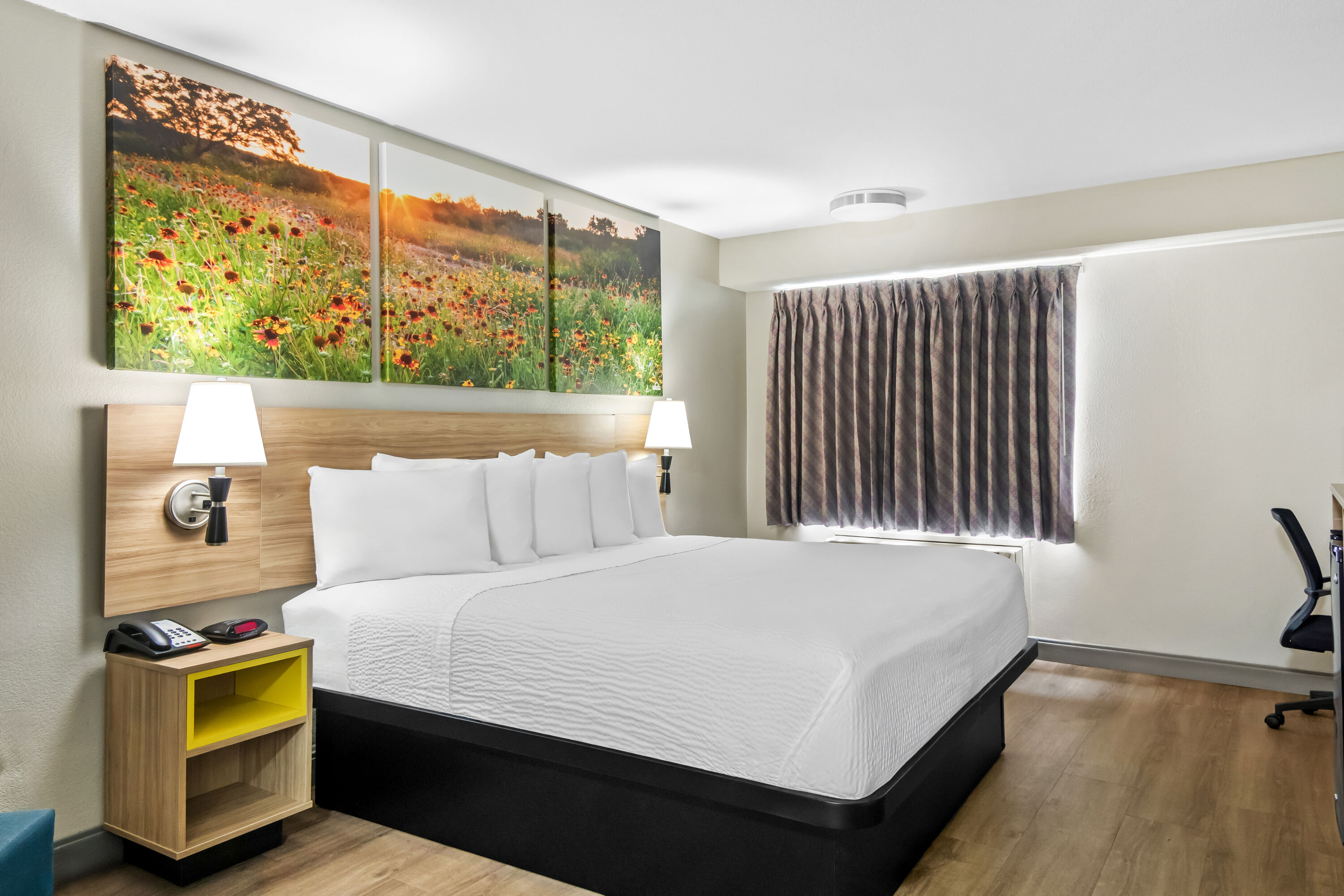 King bed guest room at the Days Inn & Suites by Wyndham DeSoto in DeSoto, Texas