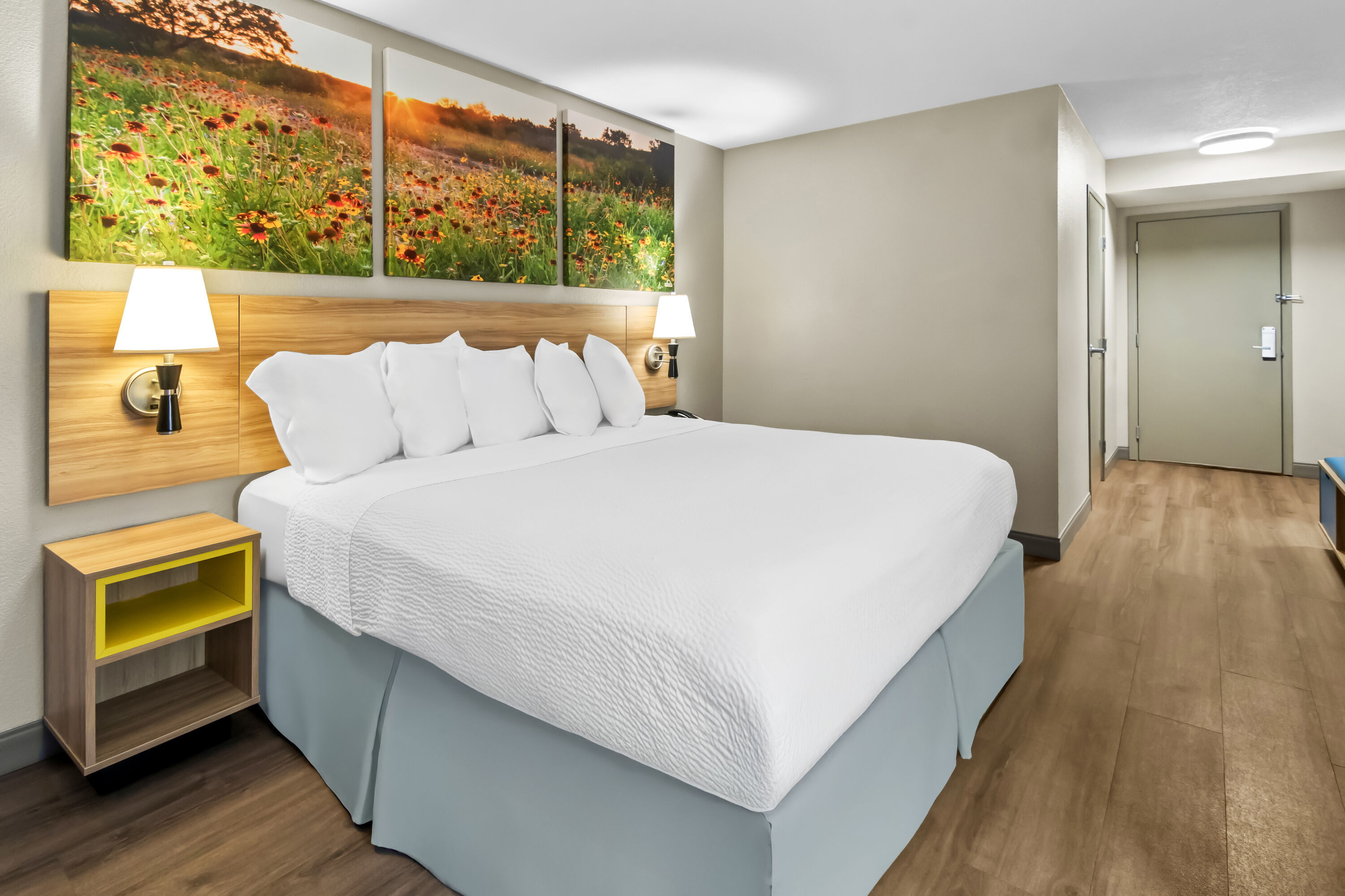 King bed guest room at the Days Inn & Suites by Wyndham DeSoto in DeSoto, Texas