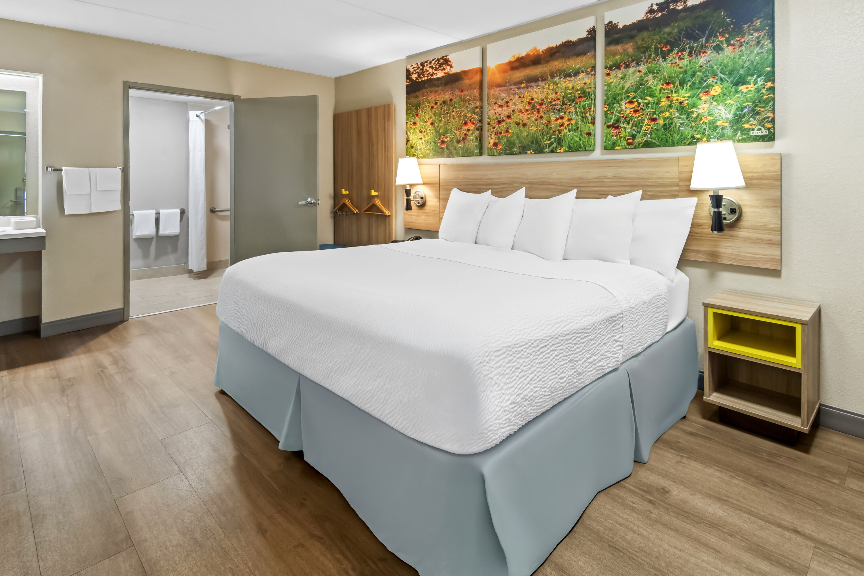 King bed guest room at the Days Inn & Suites by Wyndham DeSoto in DeSoto, Texas