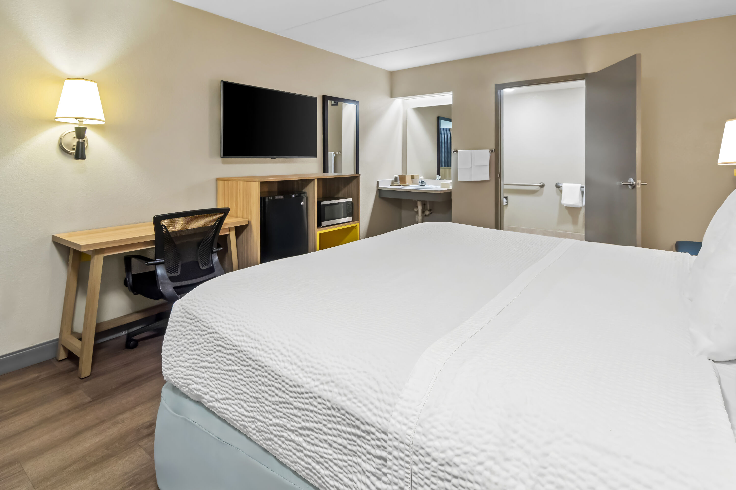 King bed guest room at the Days Inn & Suites by Wyndham DeSoto in DeSoto, Texas