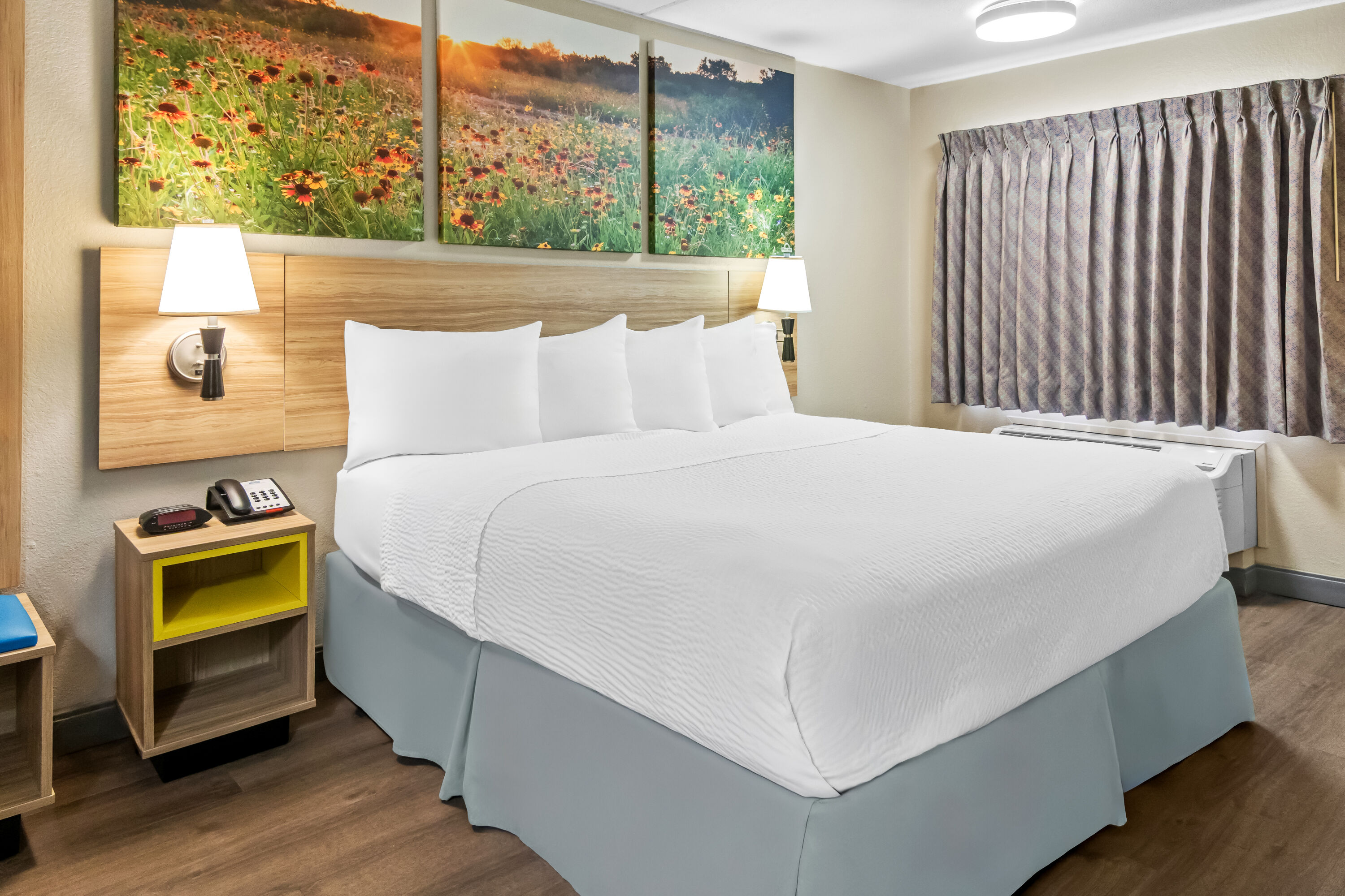 King bed guest room at the Days Inn & Suites by Wyndham DeSoto in DeSoto, Texas