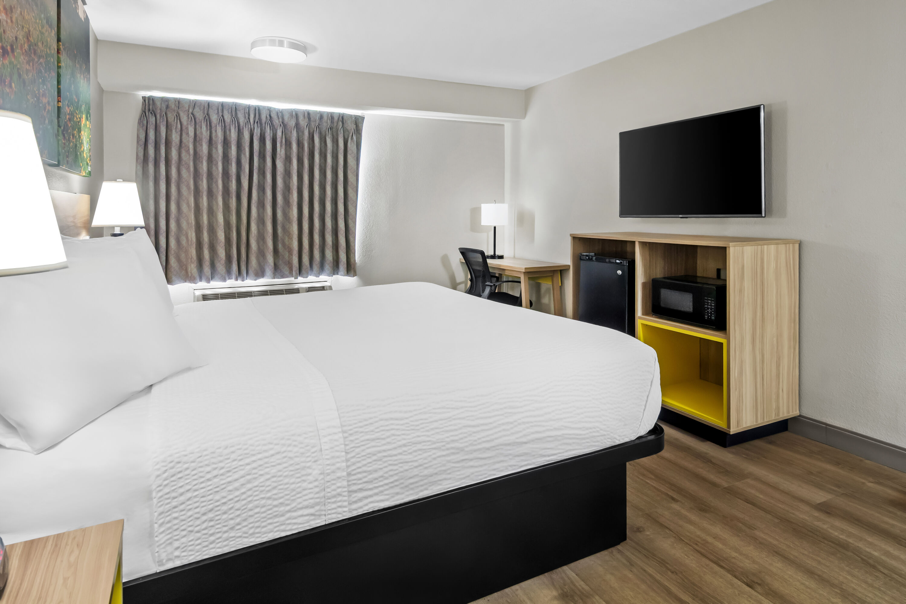 King bed guest room at the Days Inn & Suites by Wyndham DeSoto in DeSoto, Texas