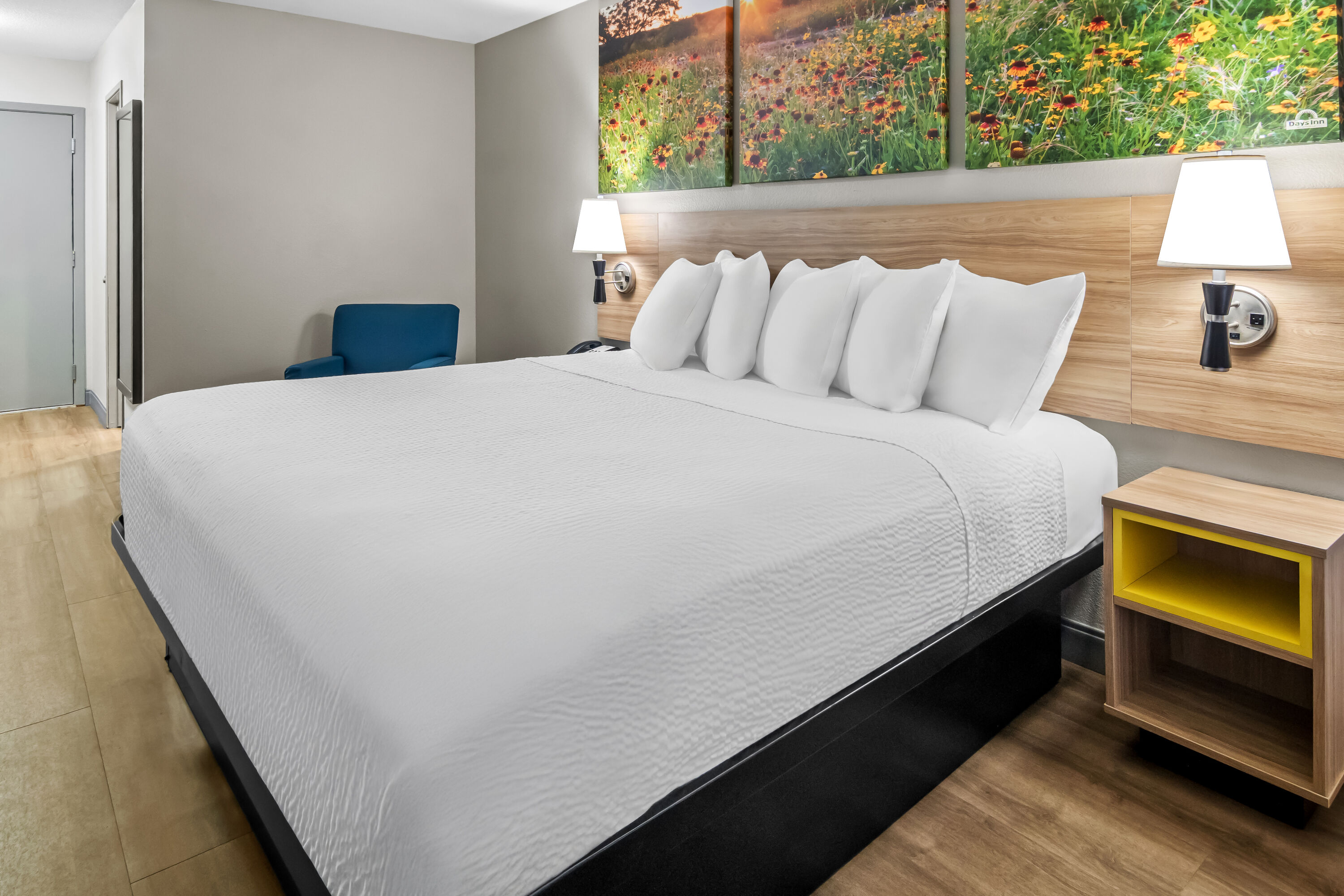 King bed guest room at the Days Inn & Suites by Wyndham DeSoto in DeSoto, Texas