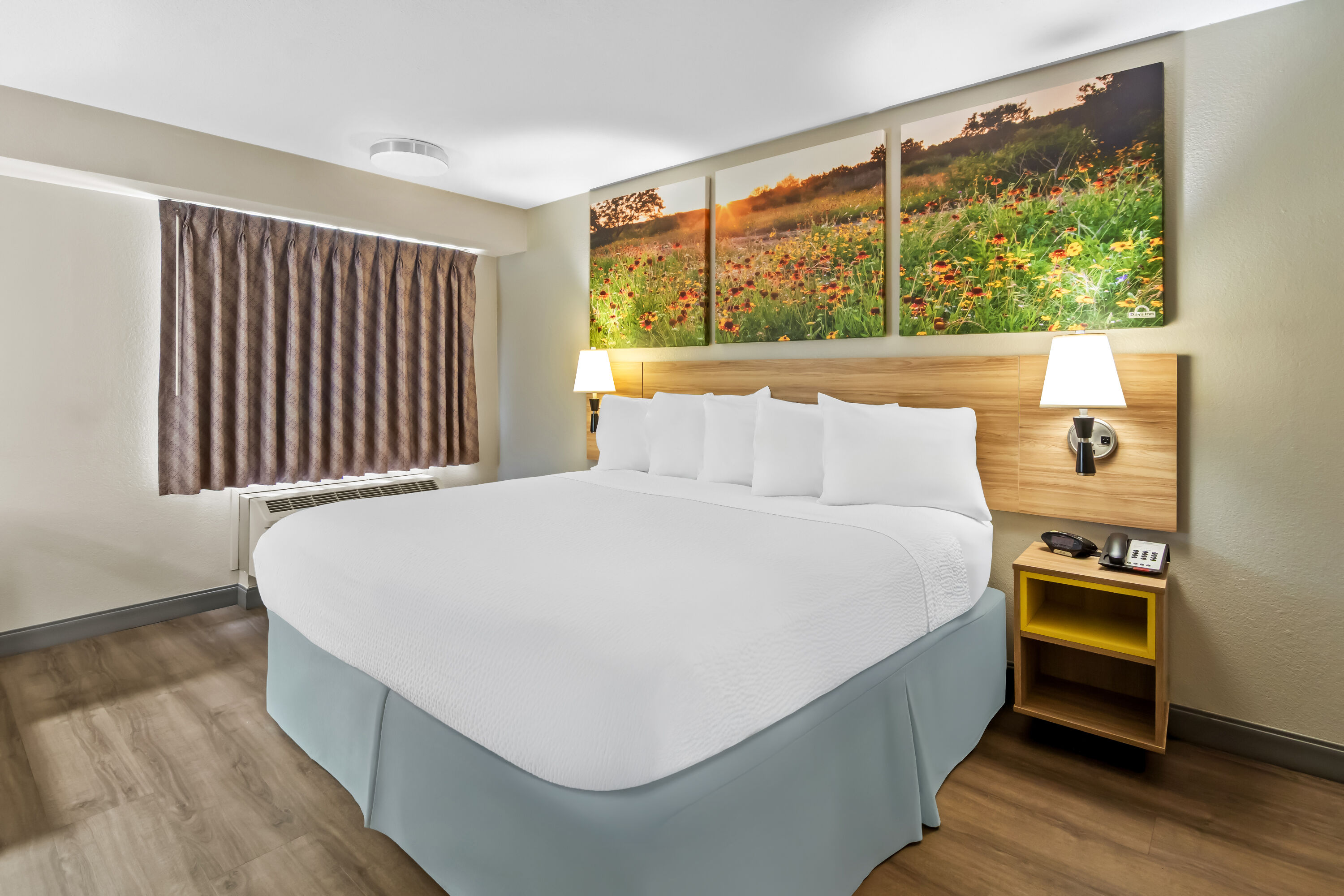 King bed guest room at the Days Inn & Suites by Wyndham DeSoto in DeSoto, Texas