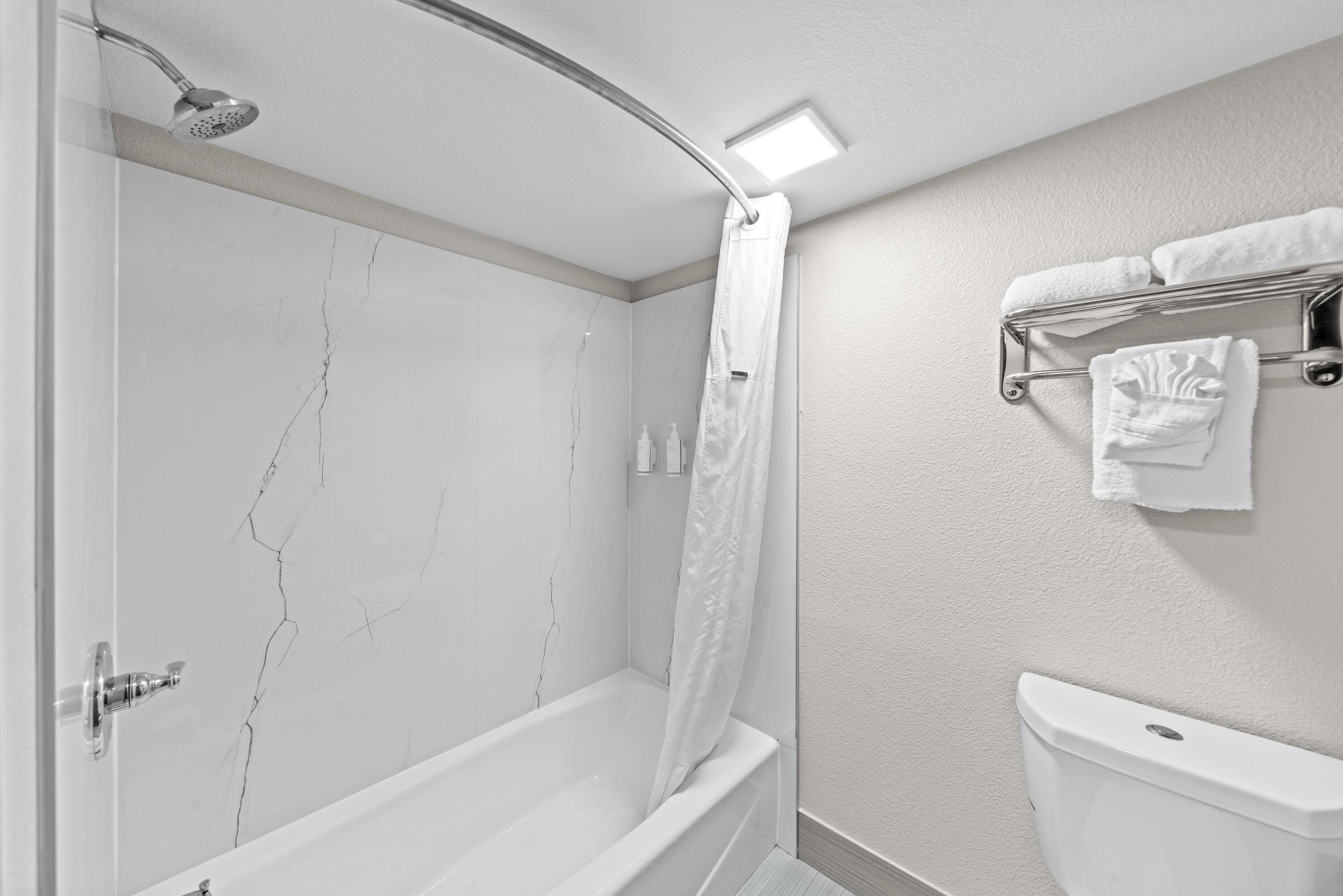 Guest room bath at the Days Inn by Wyndham Gainesville in Gainesville, Texas