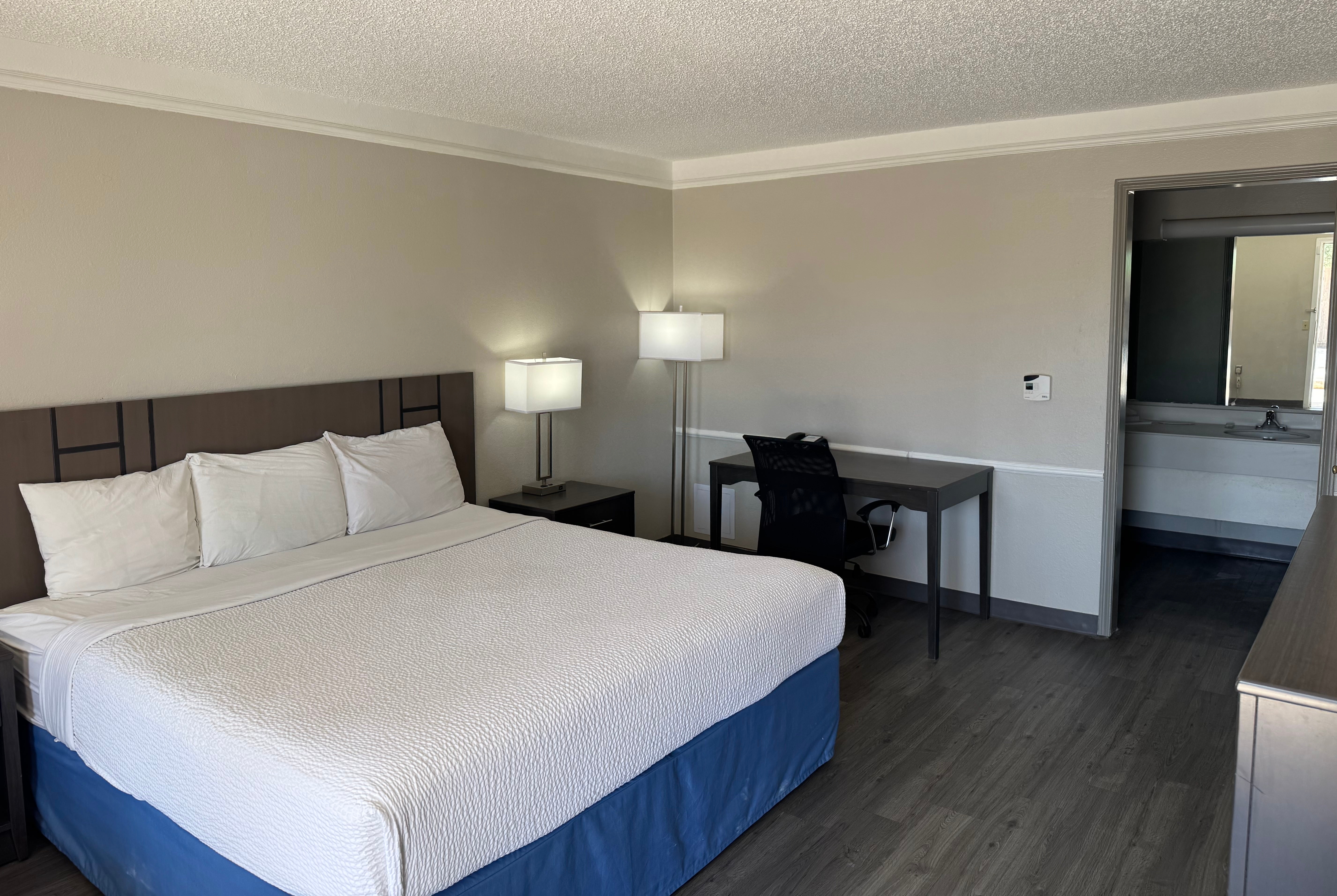 King bed guest room at the Days Inn by Wyndham Georgetown in Georgetown, Texas