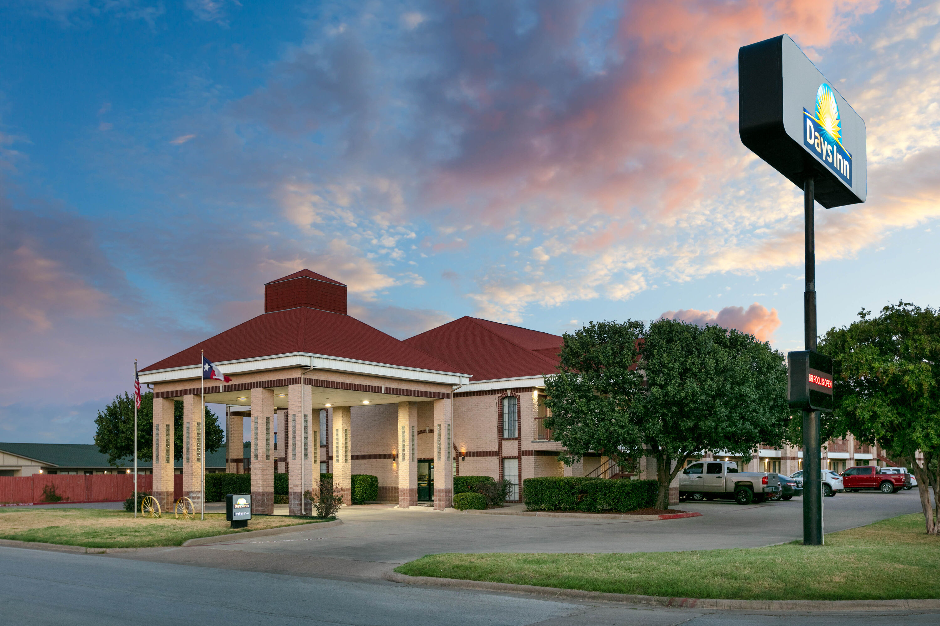 Exterior Dusk Image of Days Inn by Wyndham Granbury hotel in Granbury, Texas