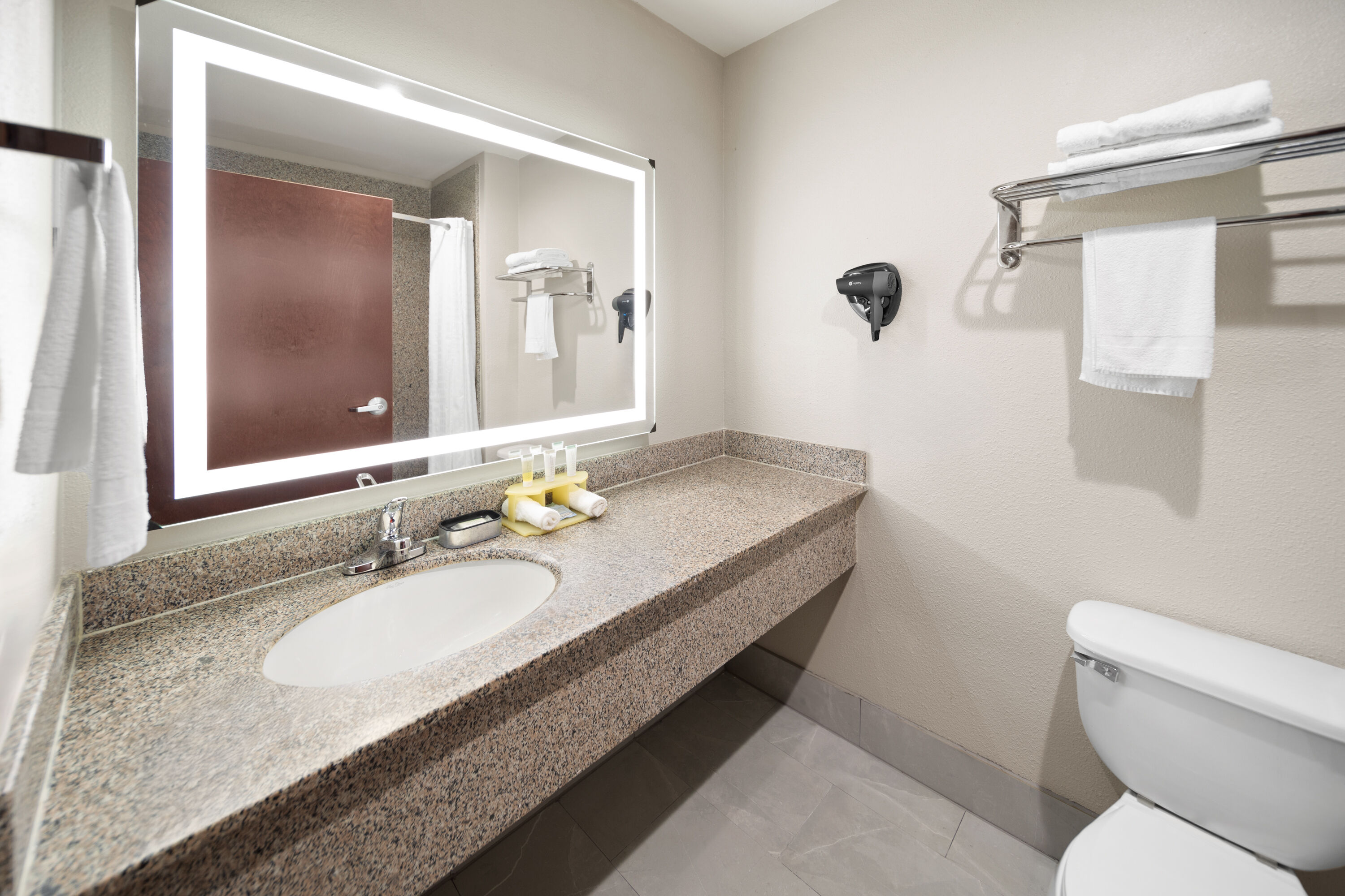 Guest room bath at the Days Inn & Suites by Wyndham Sam Houston Tollway in Houston, Texas