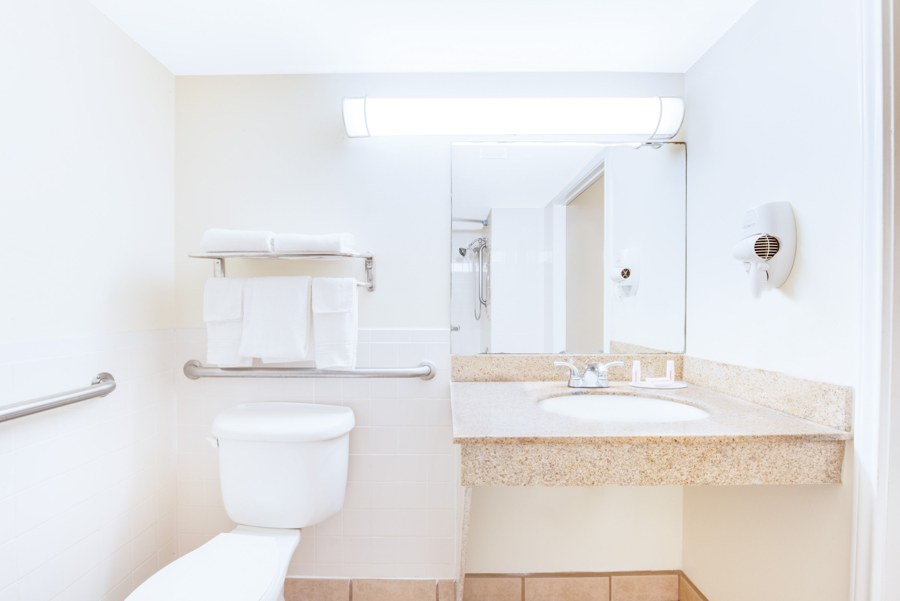 Guest room bath at the Days Inn & Suites by Wyndham Laredo in Laredo, Texas