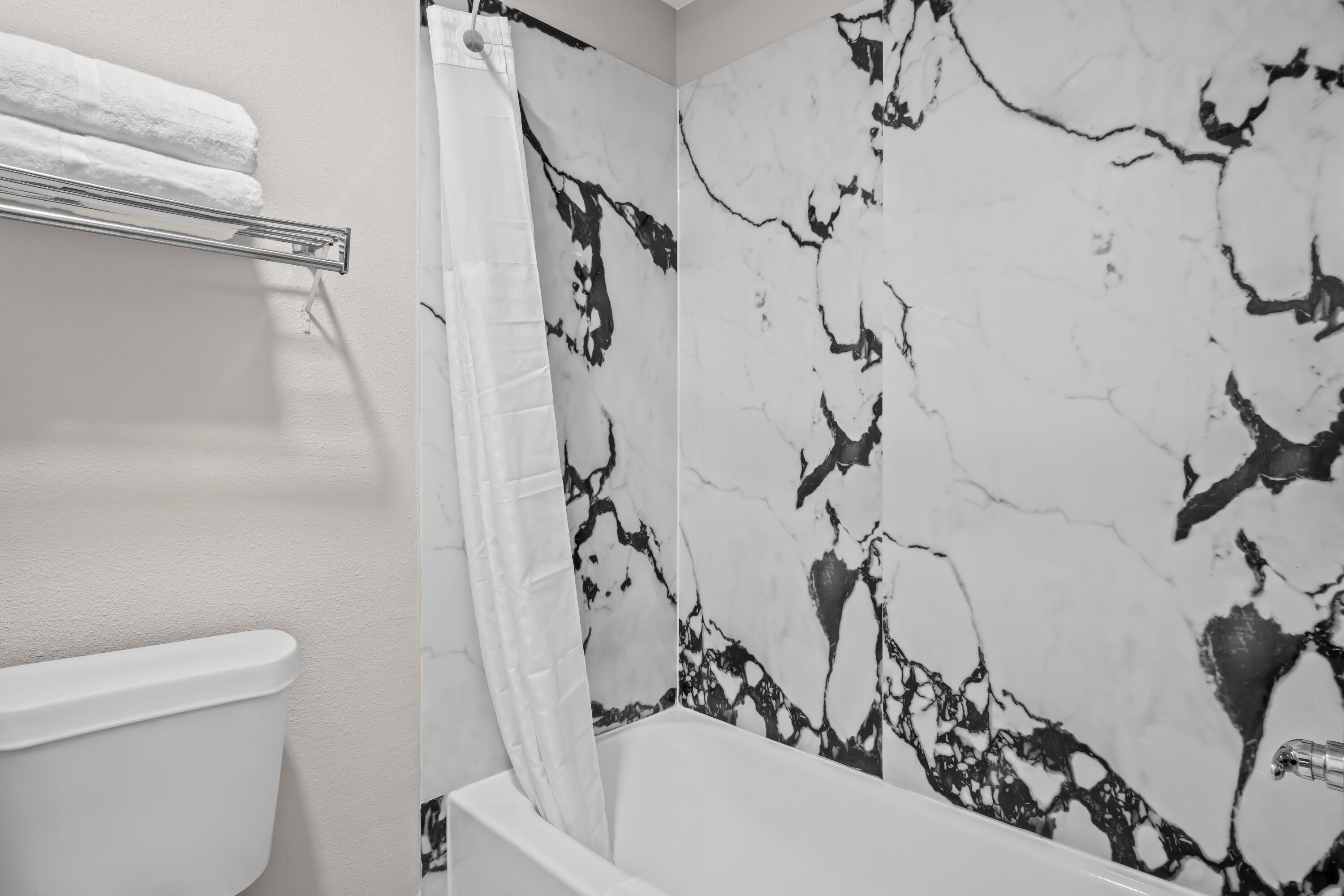 Guest room bath at the Days Inn by Wyndham Dallas Plano in Plano, Texas