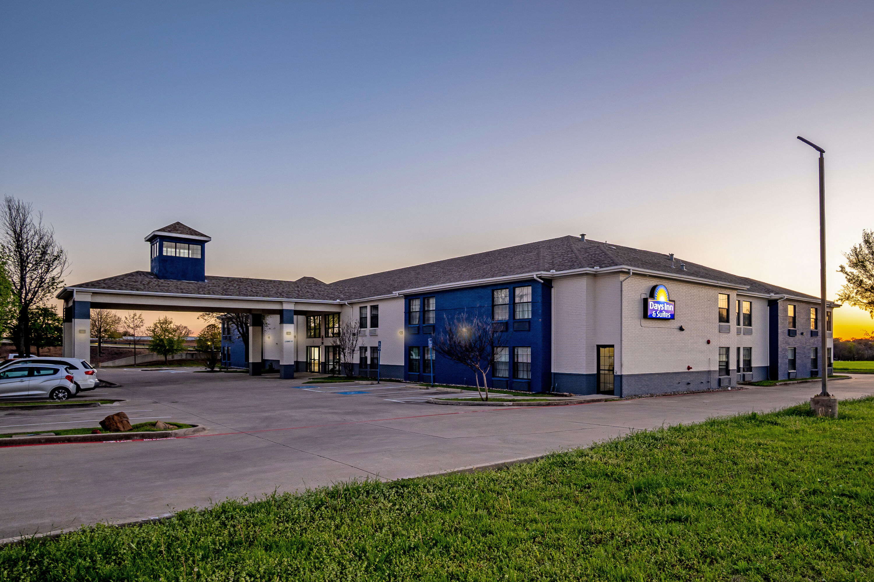 Exterior Night Image of Days Inn by Wyndham Dallas Plano hotel in Plano, Texas