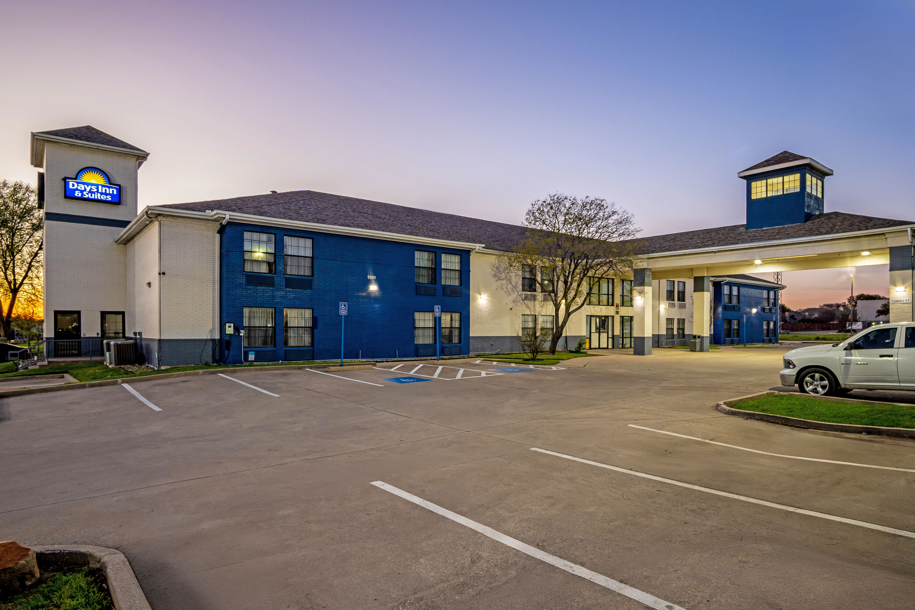 Exterior Night Image of Days Inn by Wyndham Dallas Plano hotel in Plano, Texas