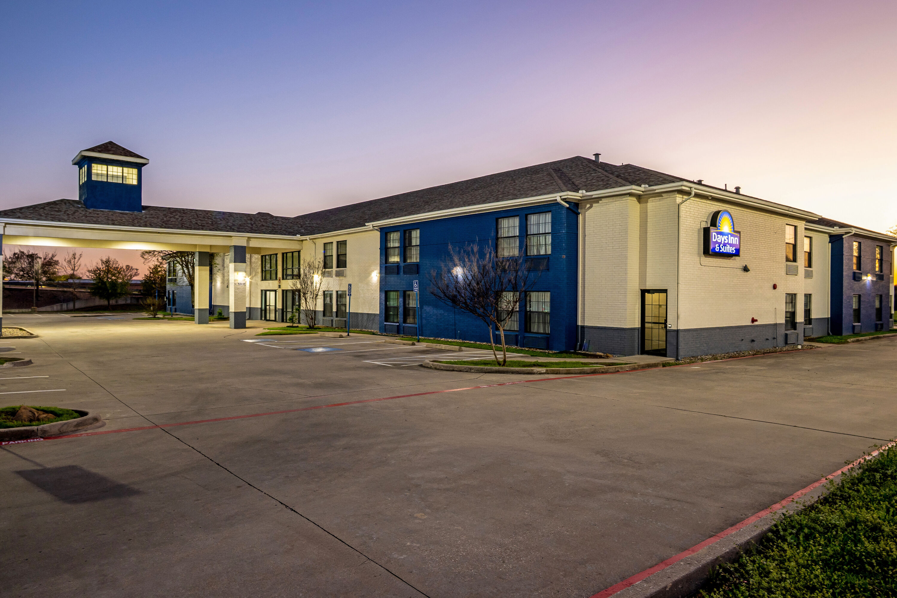 Exterior Night Image of Days Inn by Wyndham Dallas Plano hotel in Plano, Texas