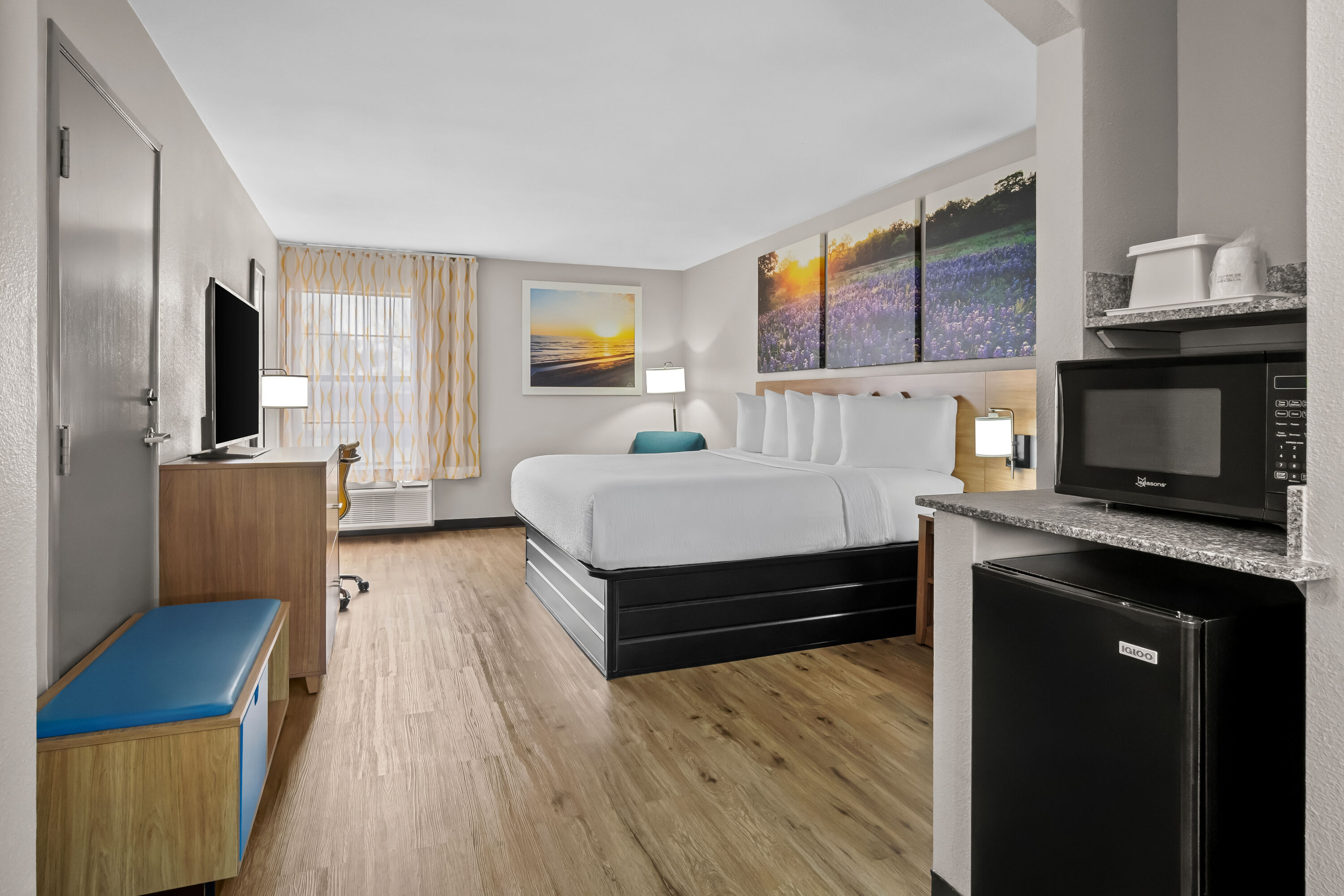 King bed guest room at the Days Inn by Wyndham Dallas Plano in Plano, Texas