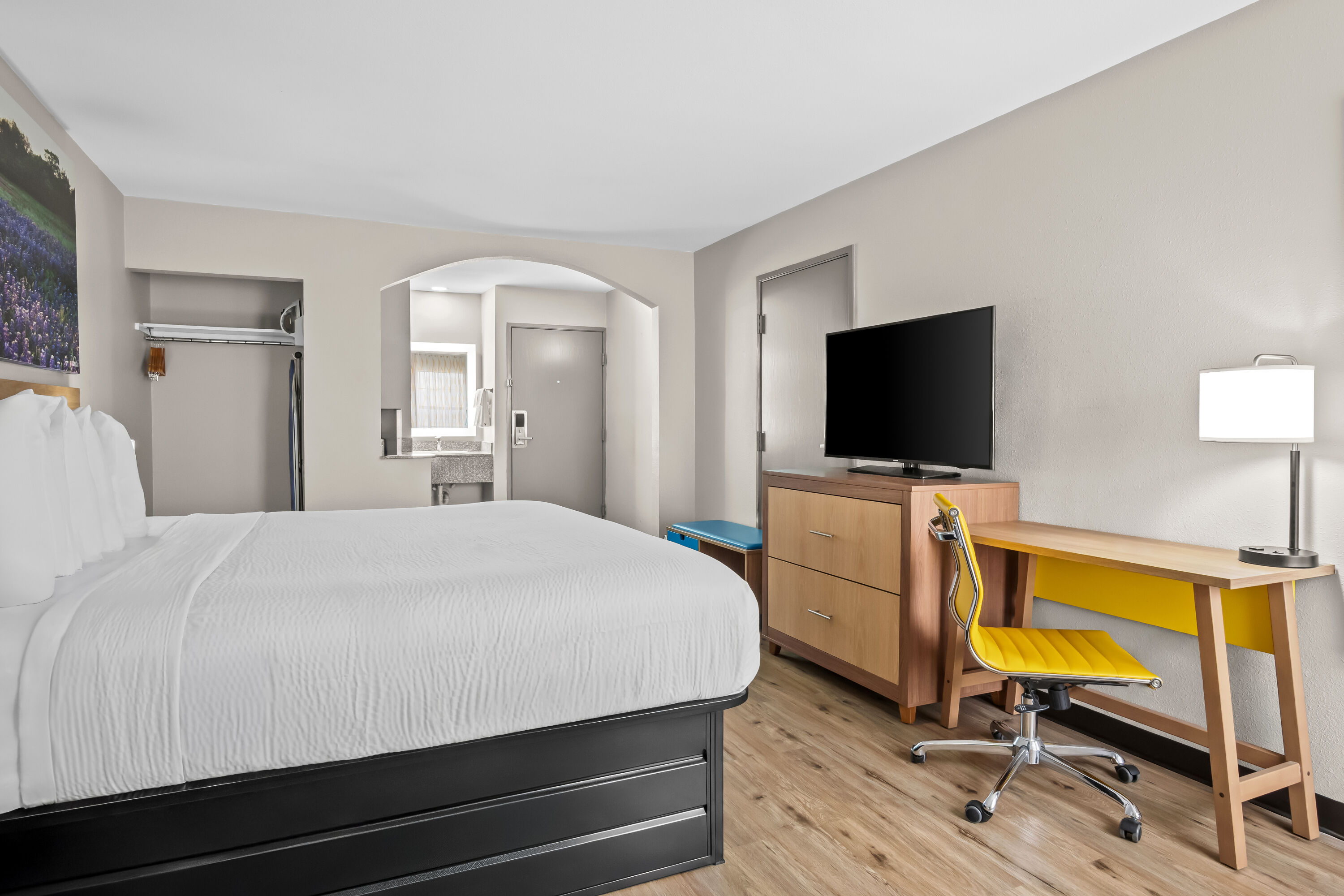 King bed guest room at the Days Inn by Wyndham Dallas Plano in Plano, Texas