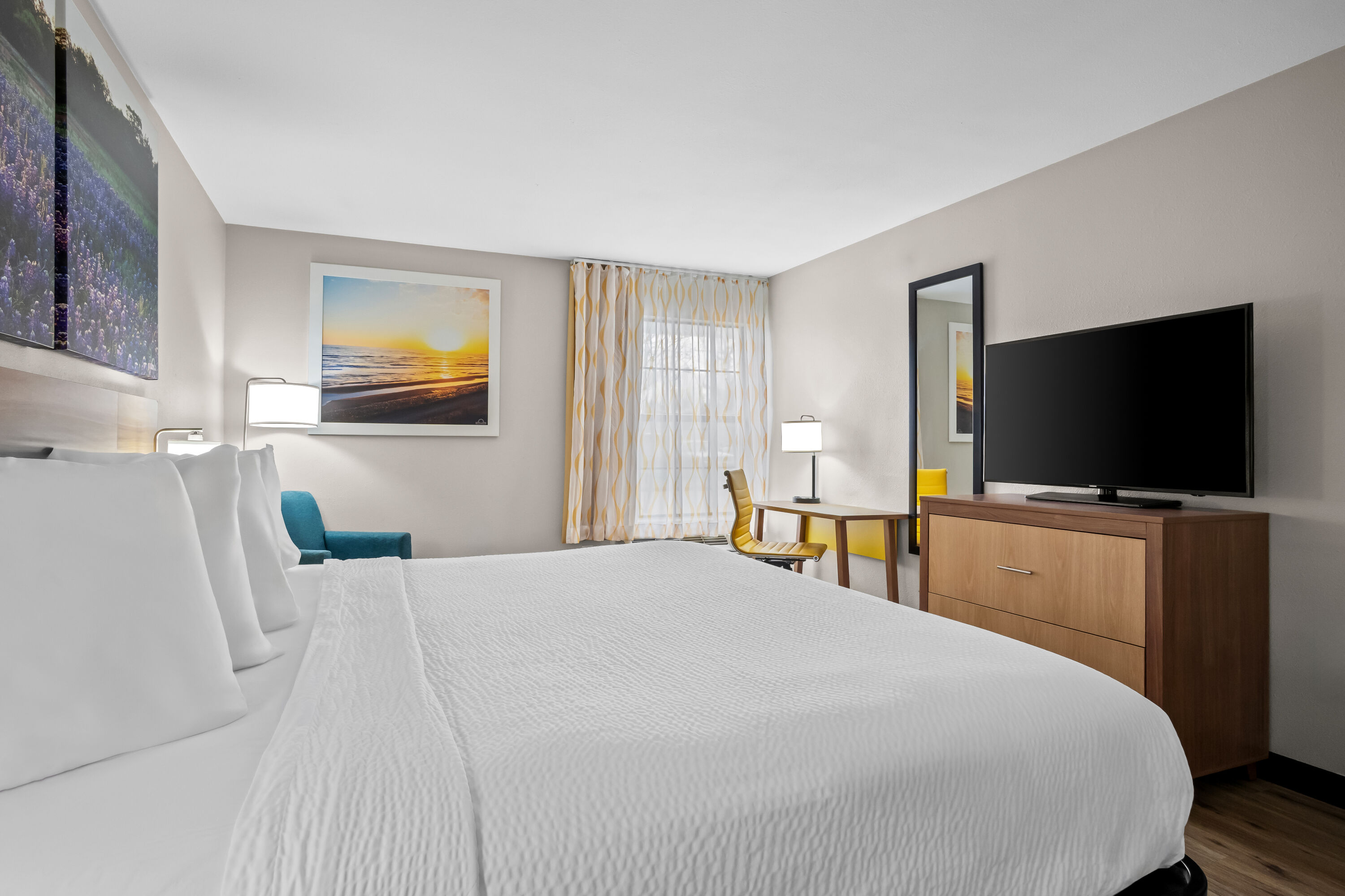 King bed guest room at the Days Inn by Wyndham Dallas Plano in Plano, Texas