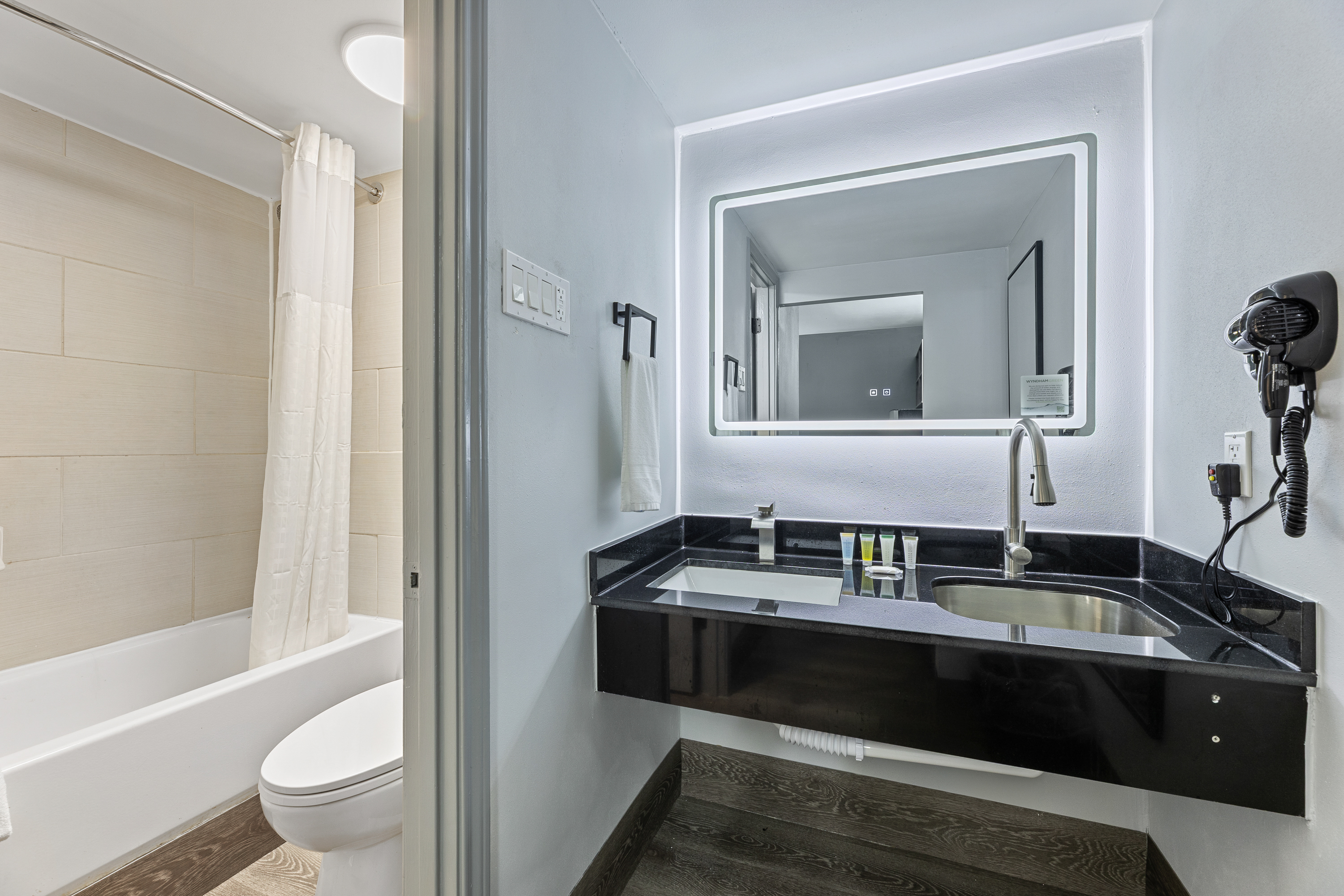 Guest room bath at the Days Inn & Suites by Wyndham Texas City/Galveston Area in Texas City, Texas