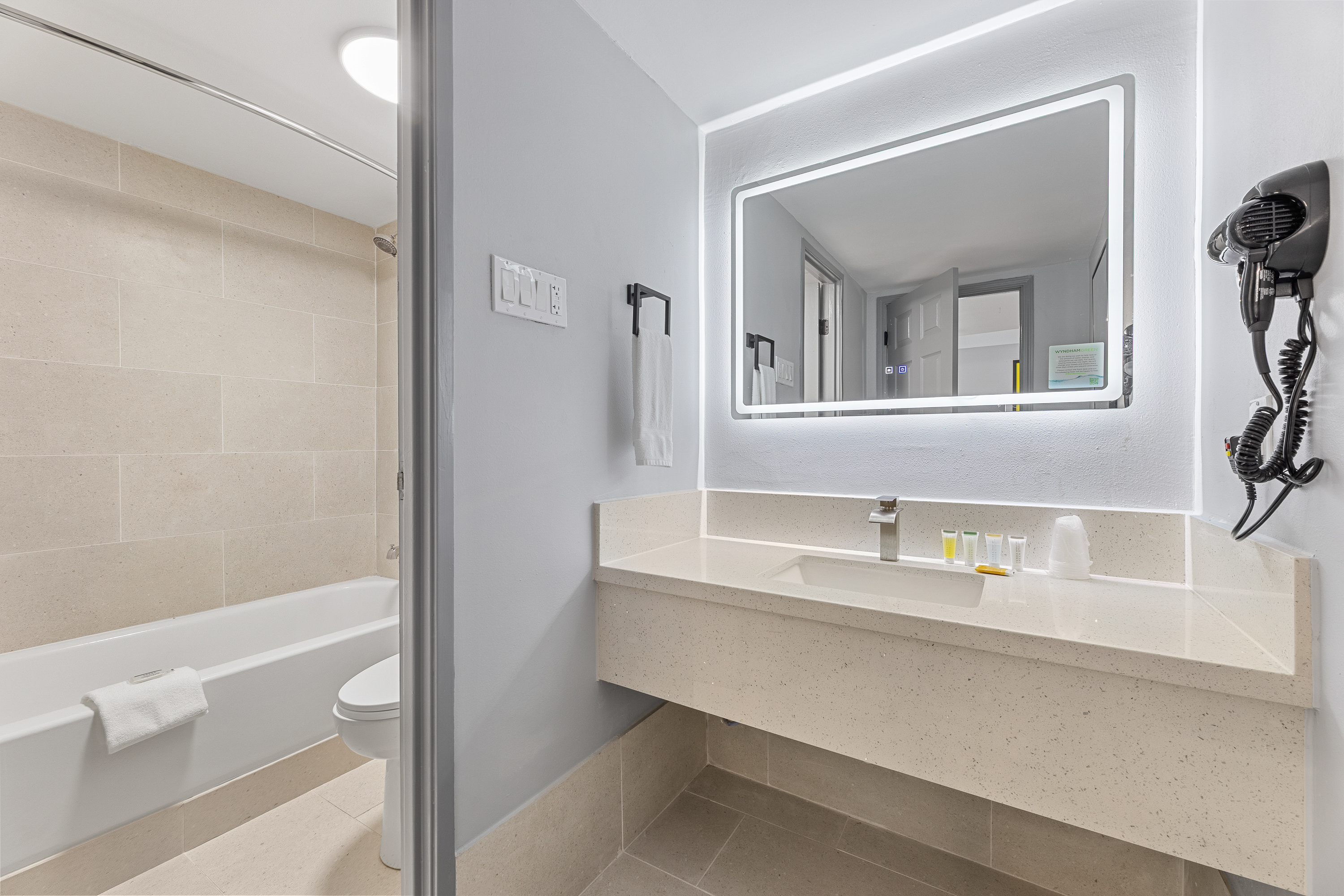 Guest room bath at the Days Inn & Suites by Wyndham Texas City/Galveston Area in Texas City, Texas