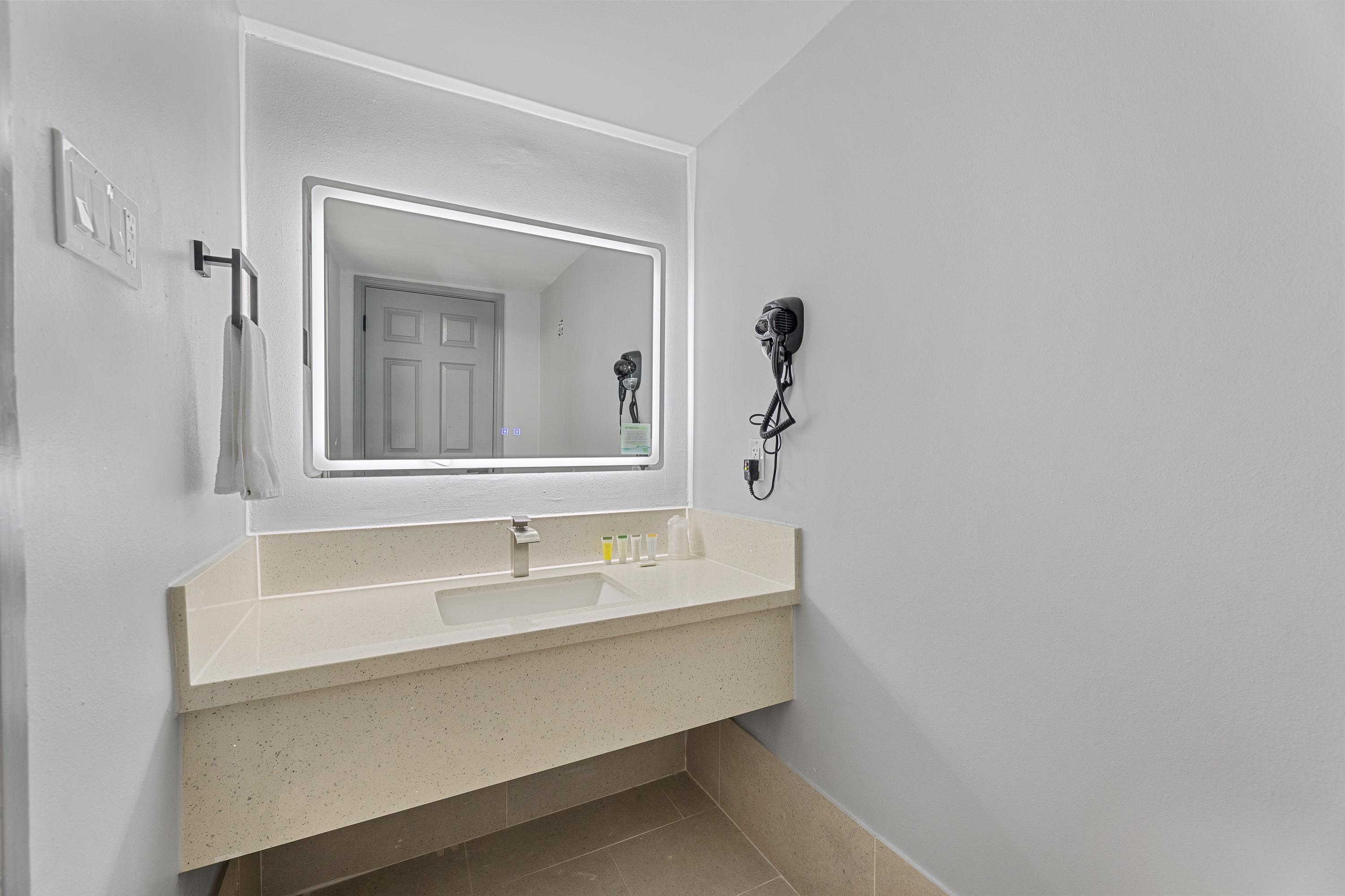 Guest room bath at the Days Inn & Suites by Wyndham Texas City/Galveston Area in Texas City, Texas