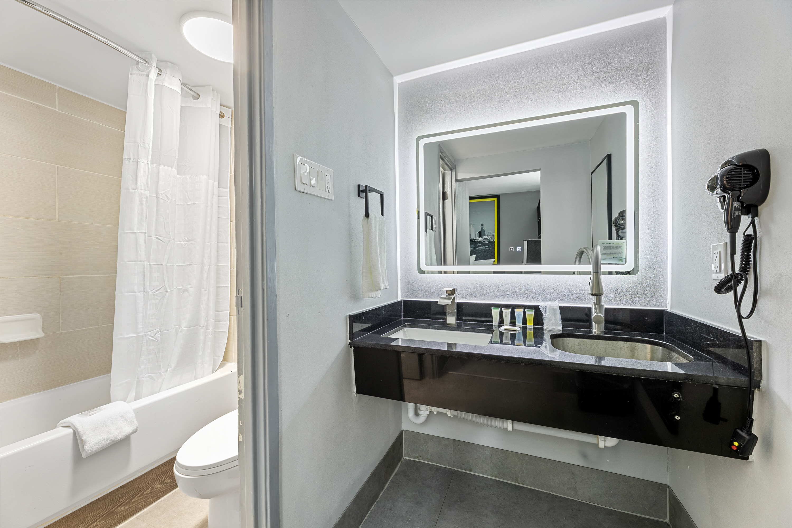 Guest room bath at the Days Inn & Suites by Wyndham Texas City/Galveston Area in Texas City, Texas