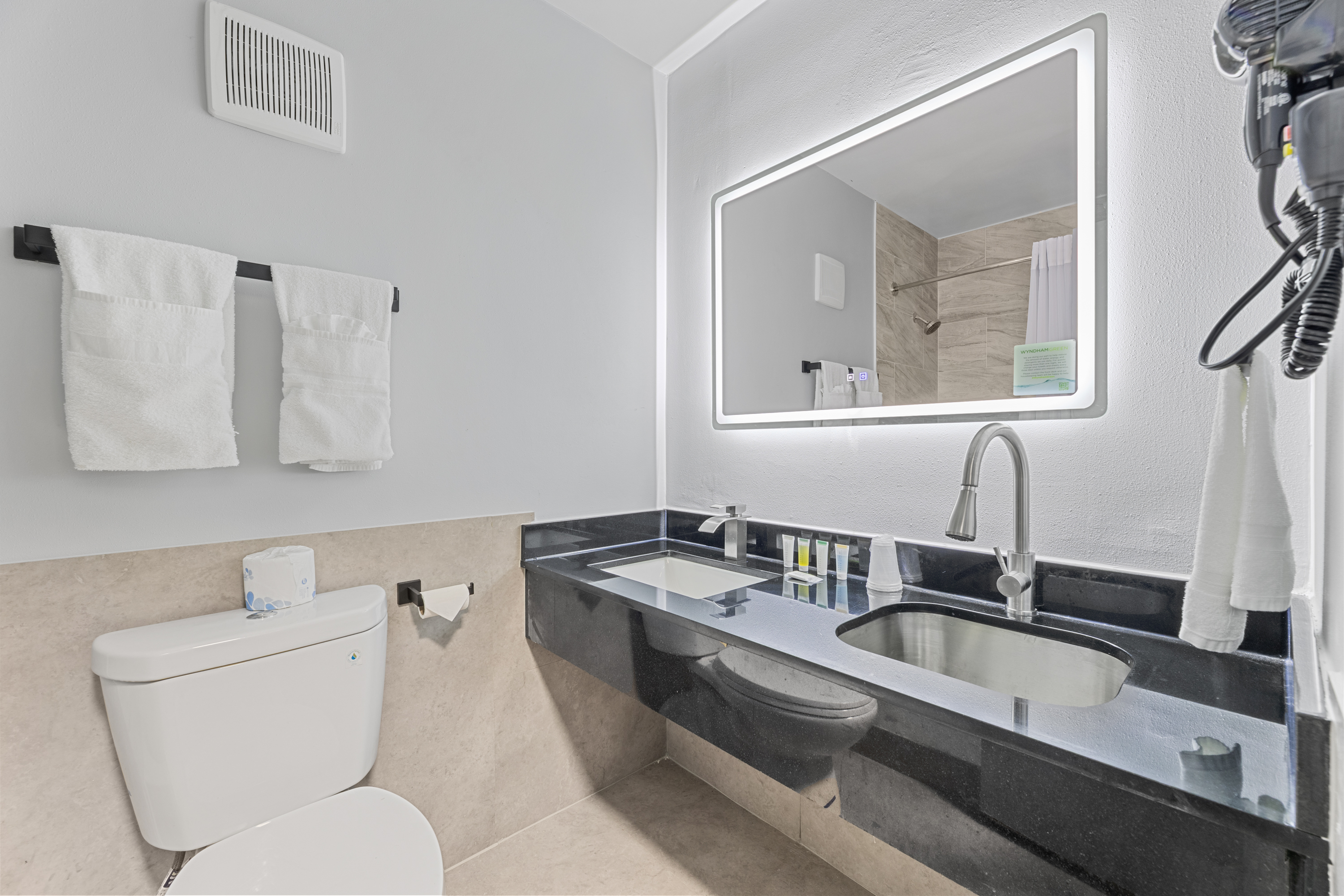 Guest room bath at the Days Inn & Suites by Wyndham Texas City in Texas City, Texas