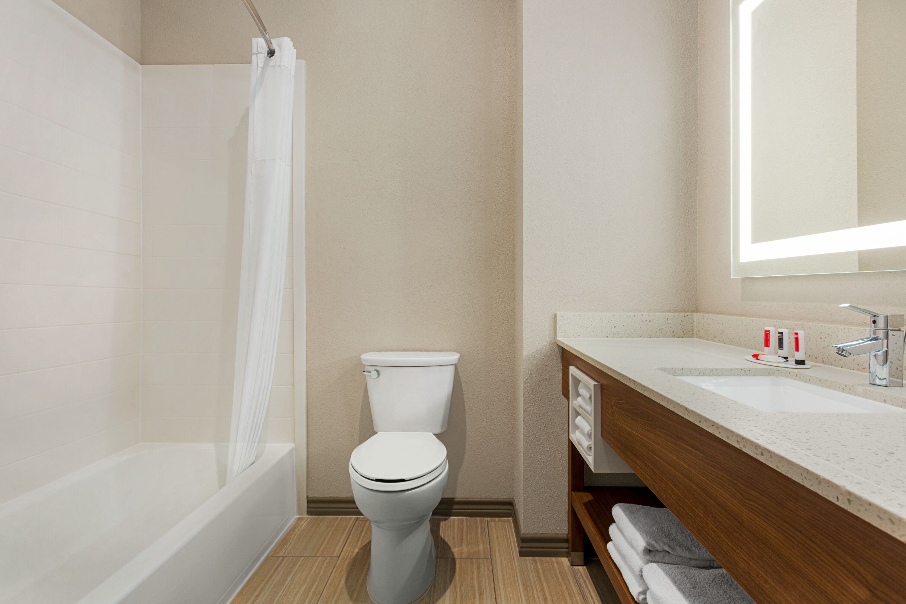 Guest room bath at the Days Inn & Suites by Wyndham Greater Tomball in Tomball, Texas