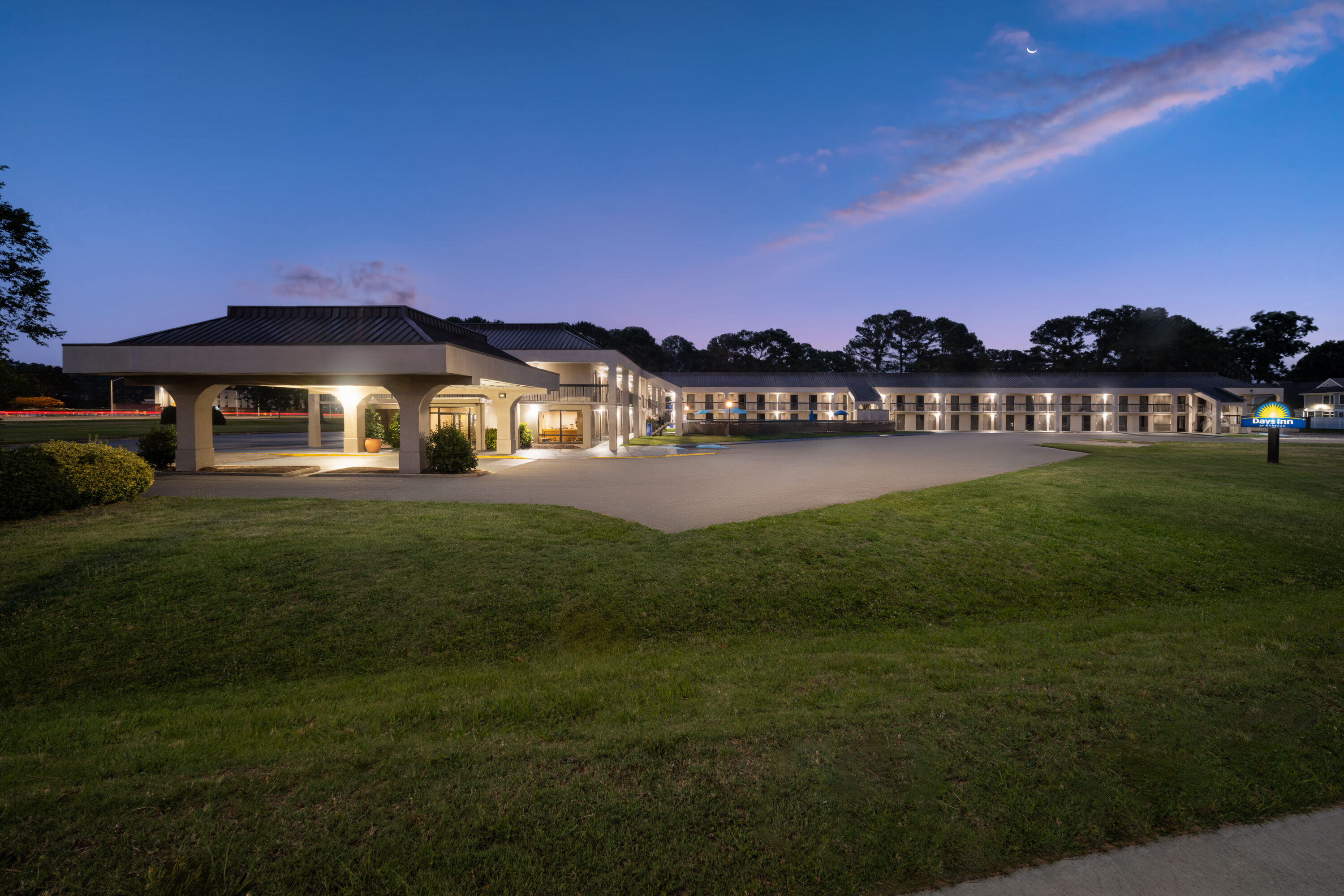 Exterior Dusk Image of Days Inn by Wyndham Norfolk Airport hotel in Norfolk, Virginia