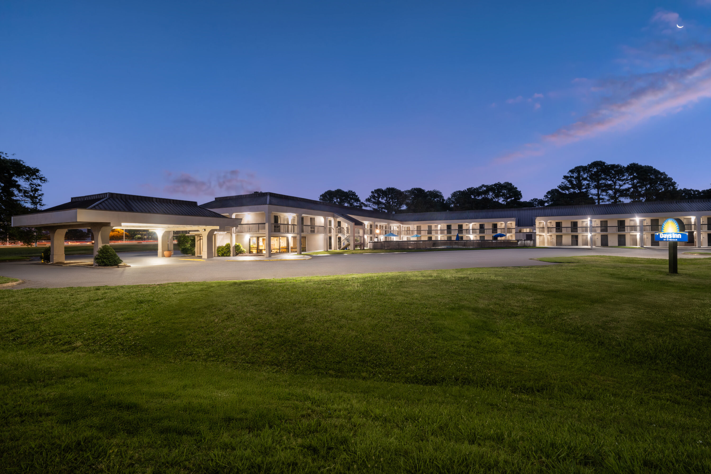 Exterior Dusk Image of Days Inn by Wyndham Norfolk Airport hotel in Norfolk, Virginia