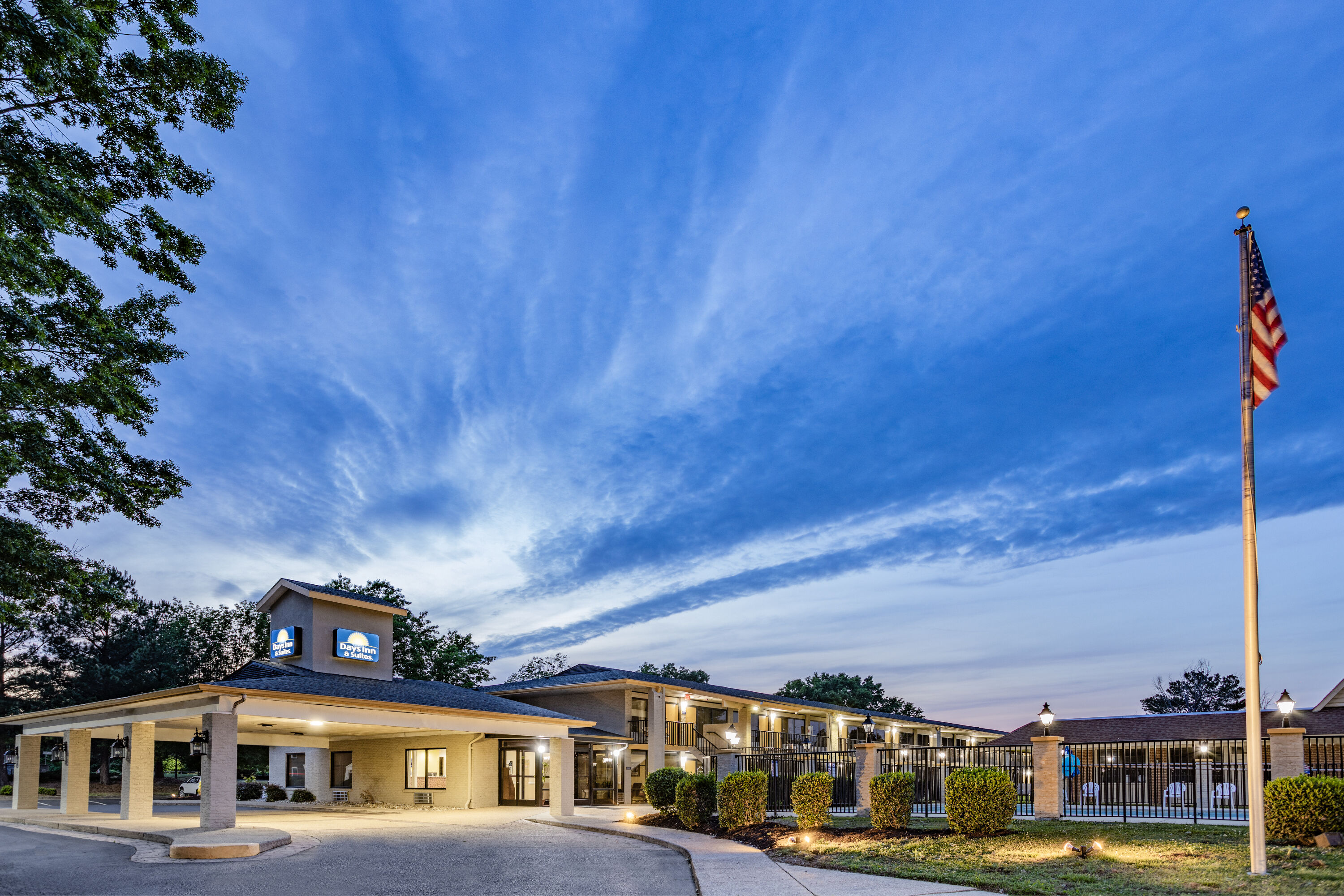 Exterior Dusk Image of Days Inn & Suites by Wyndham Williamsburg Colonial hotel in Williamsburg, Virginia
