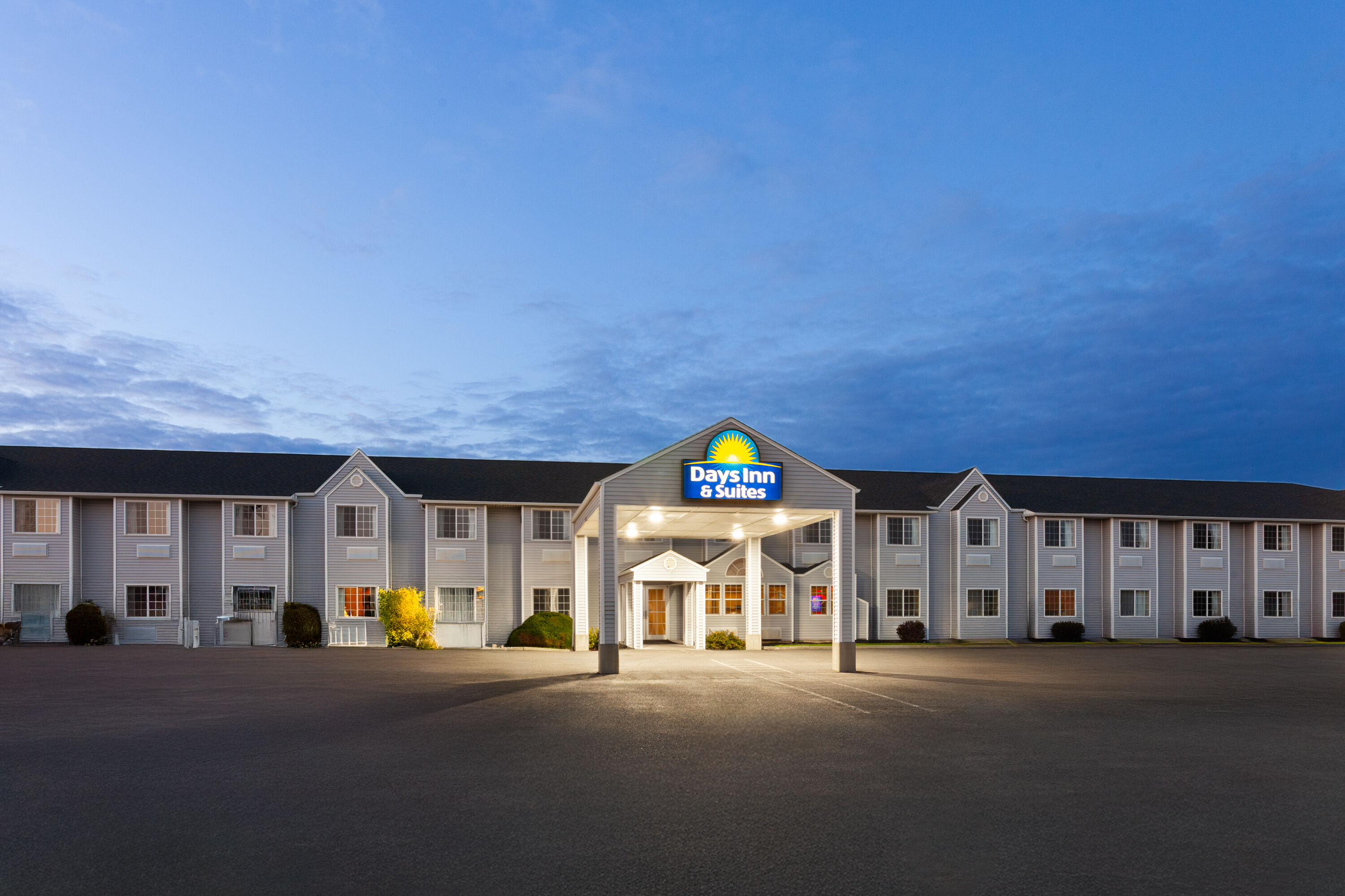 Exterior Dusk Image of Days Inn & Suites by Wyndham Spokane Airport Airway Heights hotel in Airway Heights, Washington