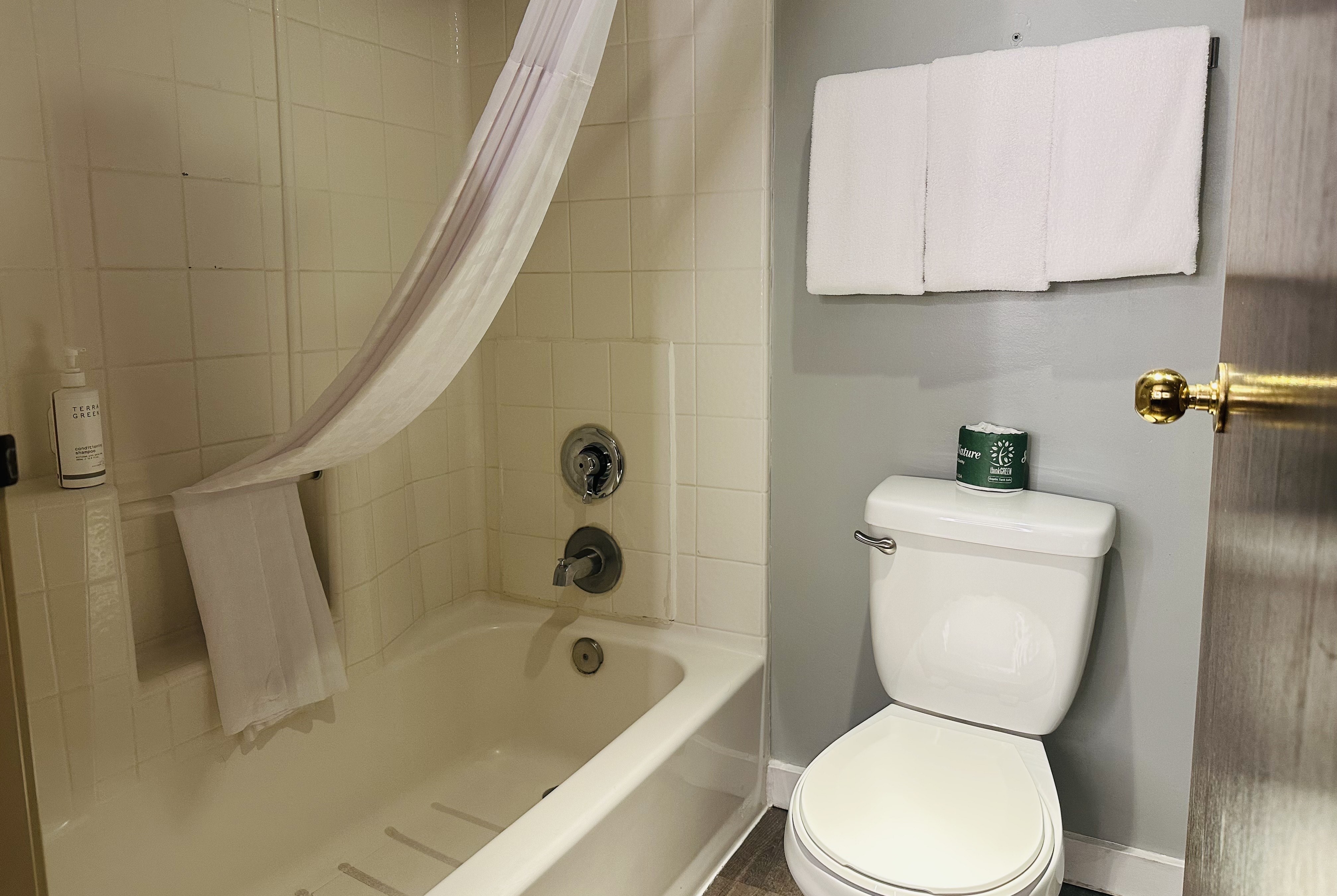 Guest room bath at the Days Inn by Wyndham Seatac Airport in Seattle, Washington