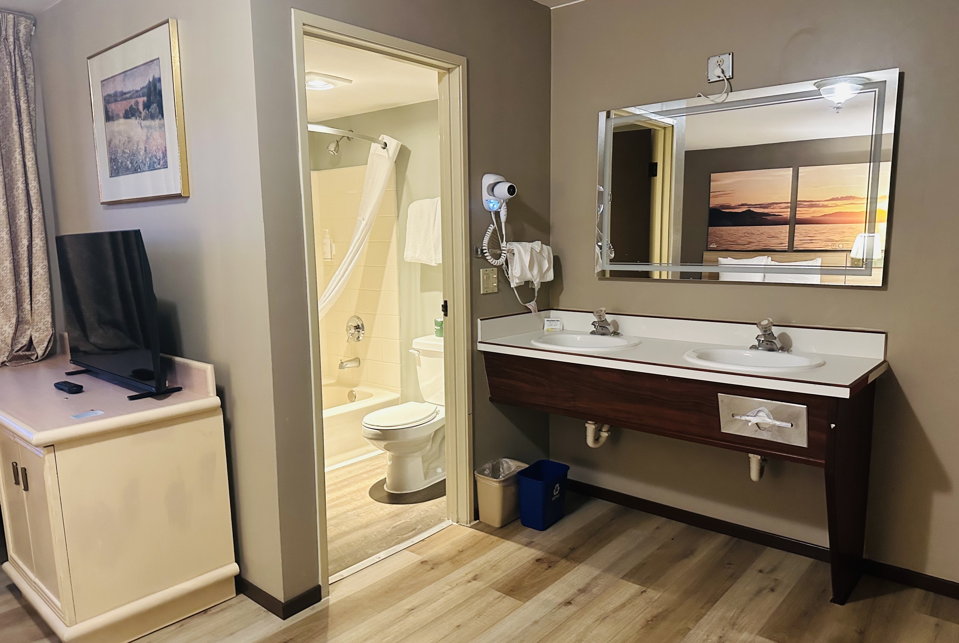 Guest room bath at the Days Inn by Wyndham Seatac Airport in Seattle, Washington