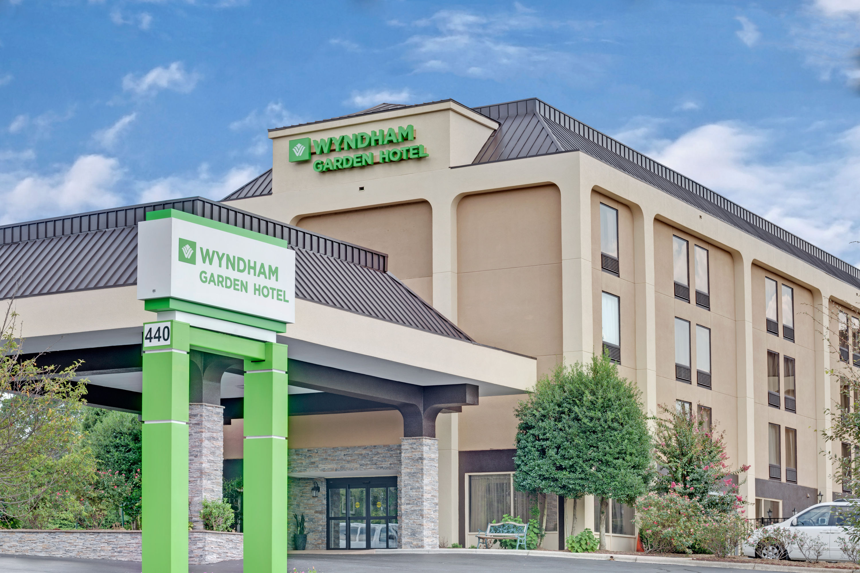 Wyndham Garden Charlotte Airport Southeast hotel exterior with green Wyndham Garden entrance signage and covered driveway