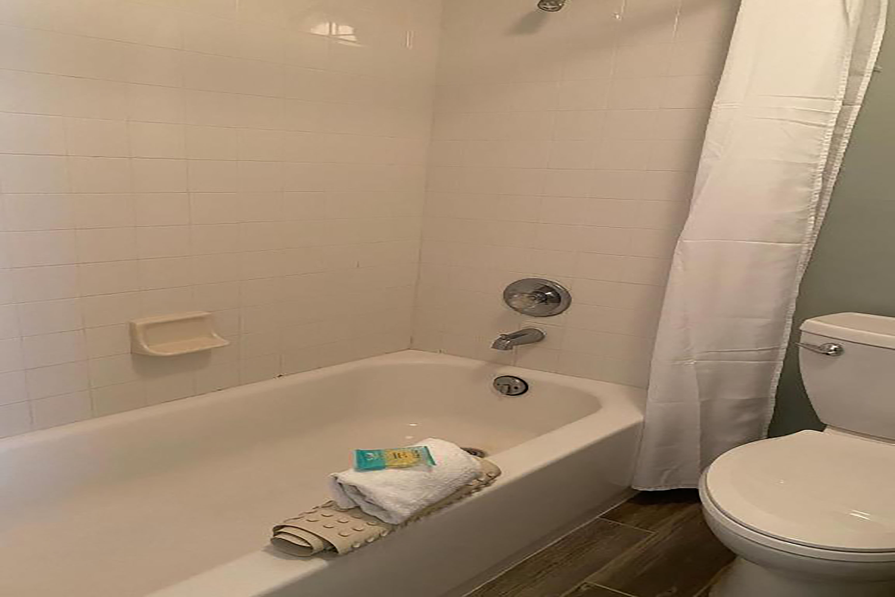 Guest room bath at the Howard Johnson by Wyndham Oceanfront Daytona Beach in Daytona Beach, Florida
