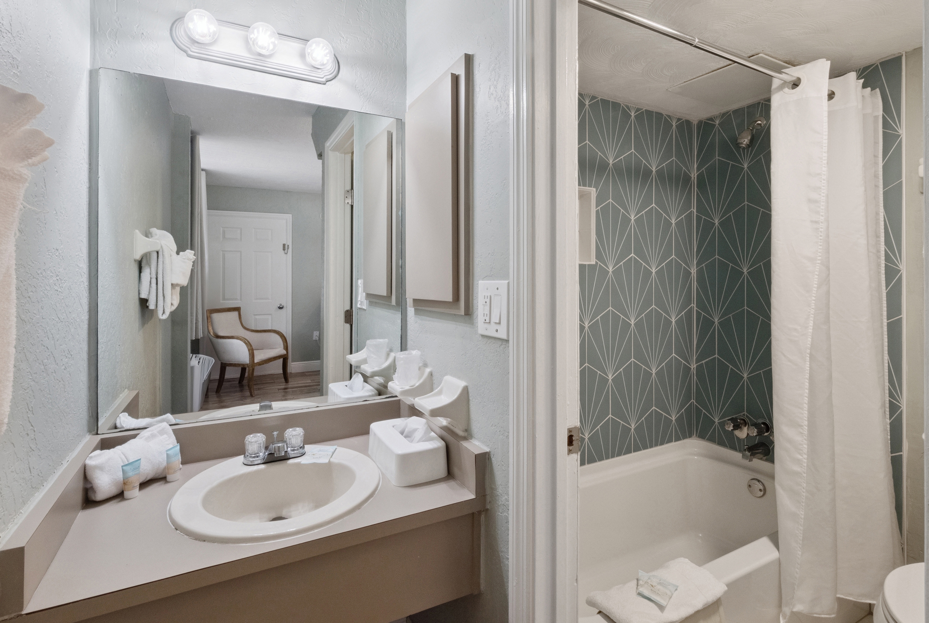 Guest room bath at the Howard Johnson by Wyndham Oceanfront Daytona Beach in Daytona Beach, Florida