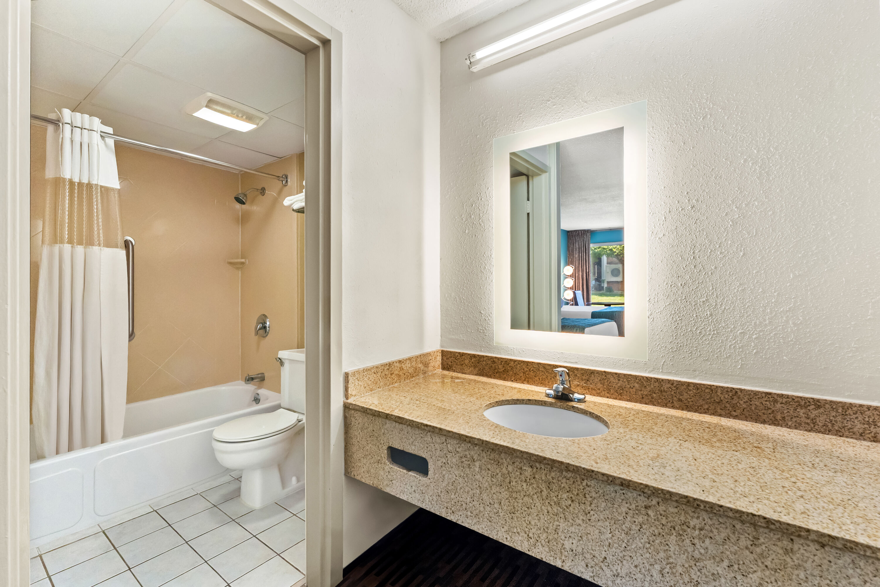 Guest room bath at the Howard Johnson by Wyndham Albany in Albany, New York