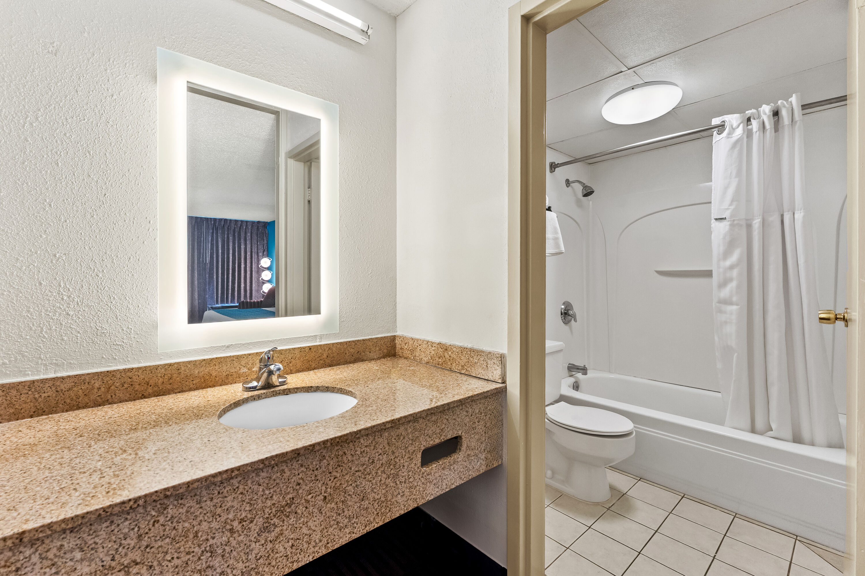 Guest room bath at the Howard Johnson by Wyndham Albany in Albany, New York