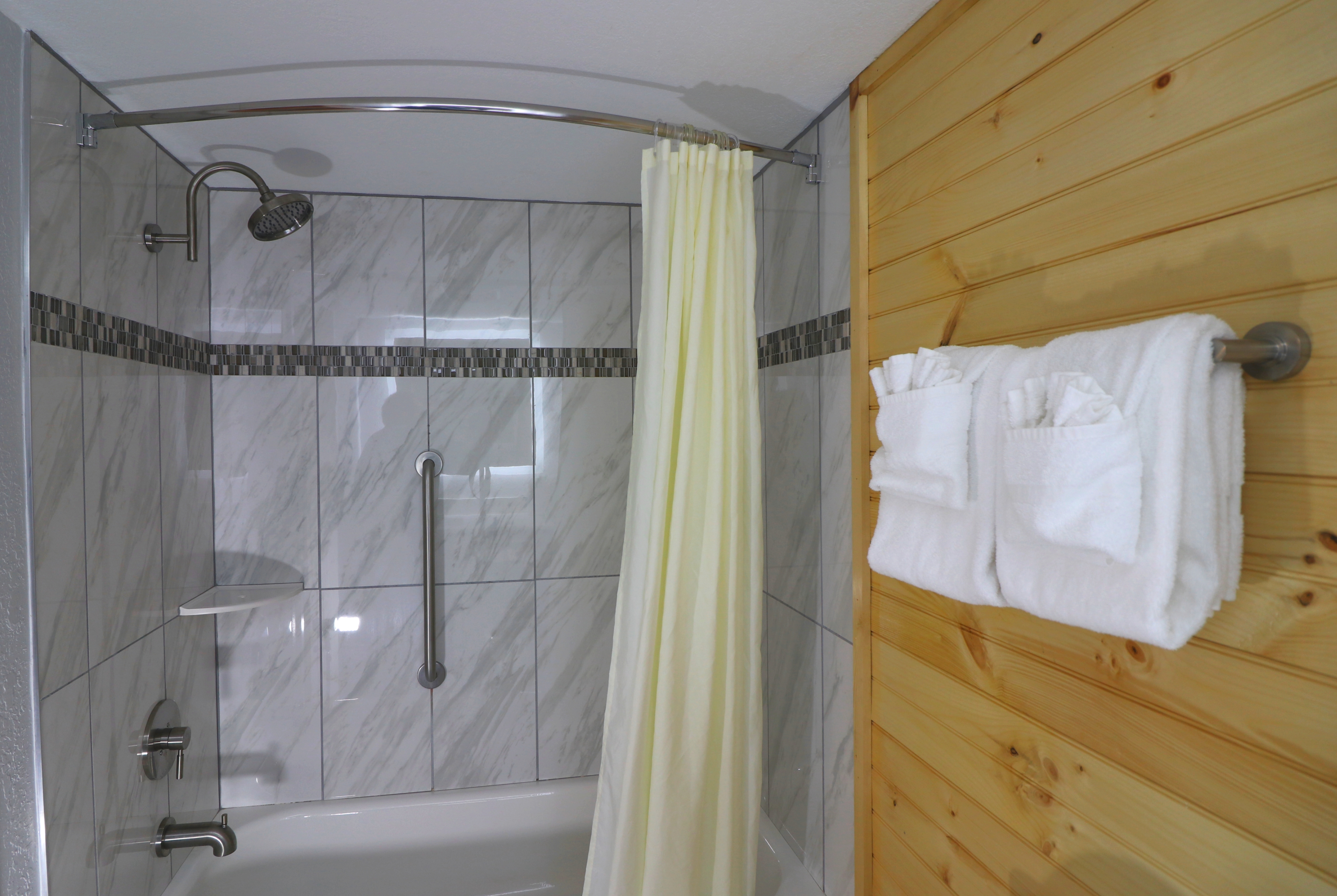 Guest room bath at the Howard Johnson by Wyndham Downtown Gatlinburg in Gatlinburg, Tennessee