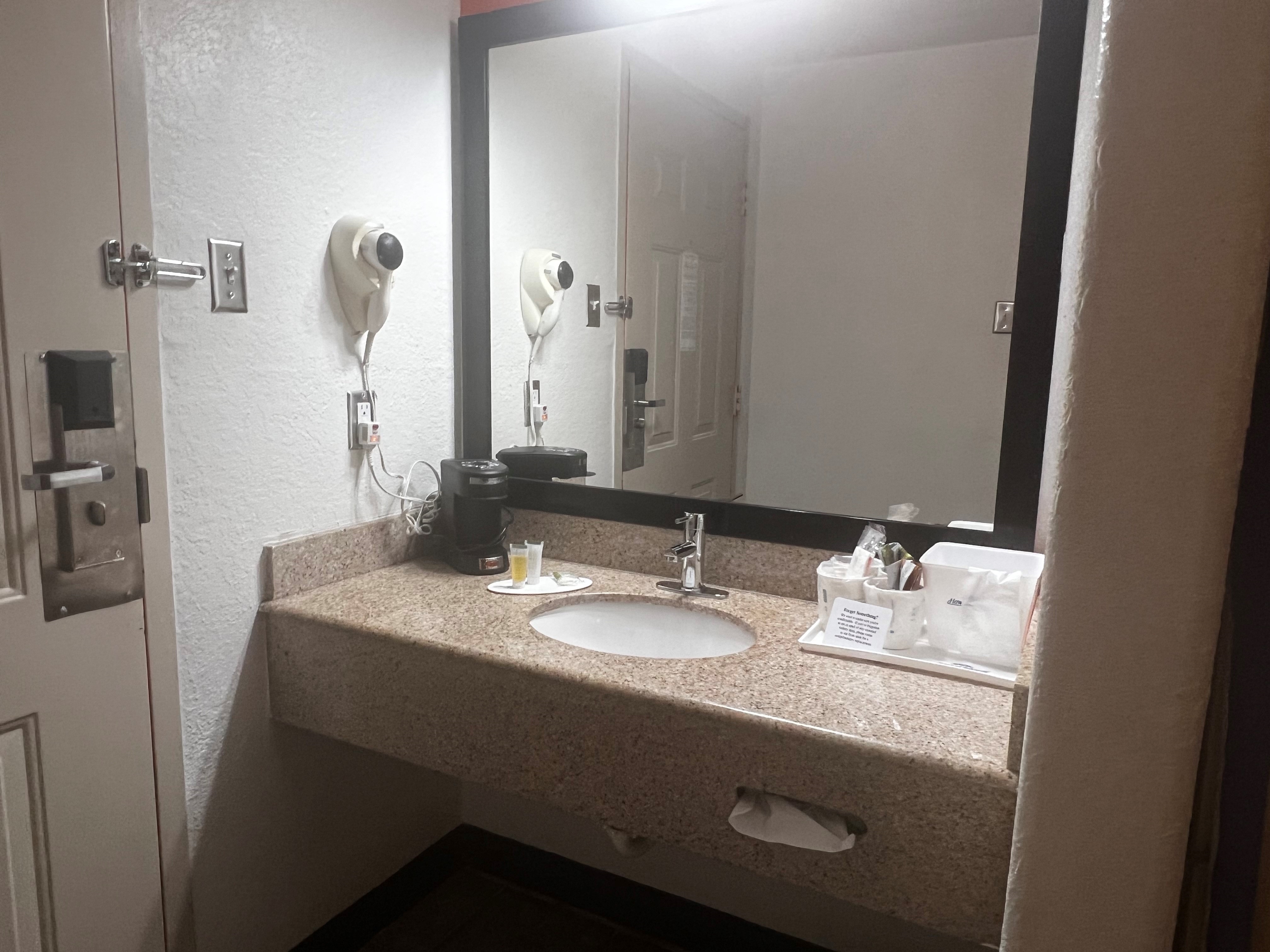 Guest room bath at the Howard Johnson by Wyndham Galveston in Galveston, Texas