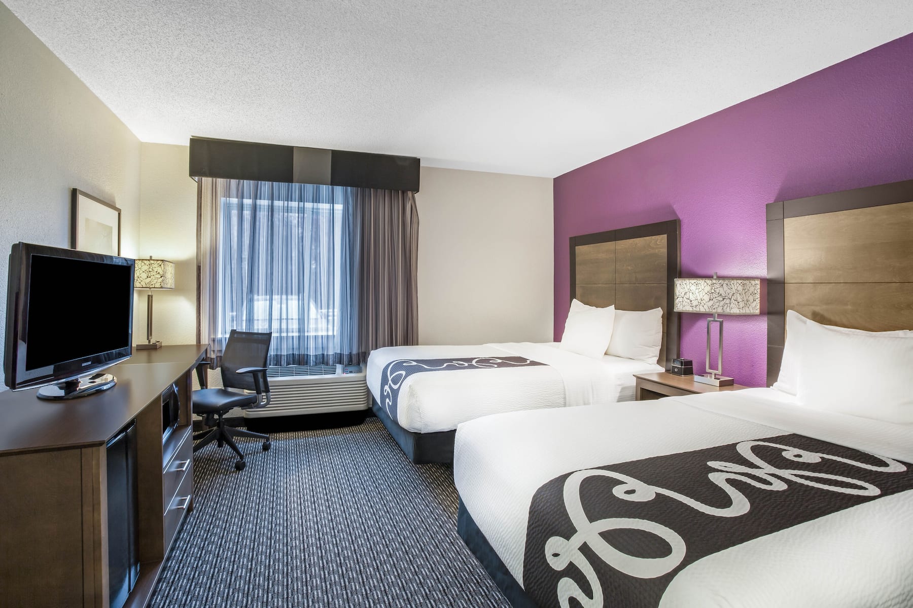 Guest room at the La Quinta Inn & Suites by Wyndham Hartford - Bradley Airport in Windsor Locks, Connecticut