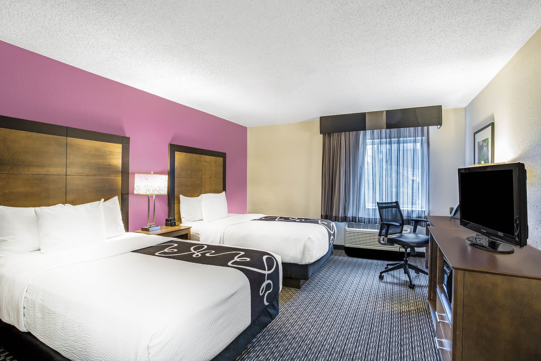 Guest room at the La Quinta Inn & Suites by Wyndham Hartford - Bradley Airport in Windsor Locks, Connecticut