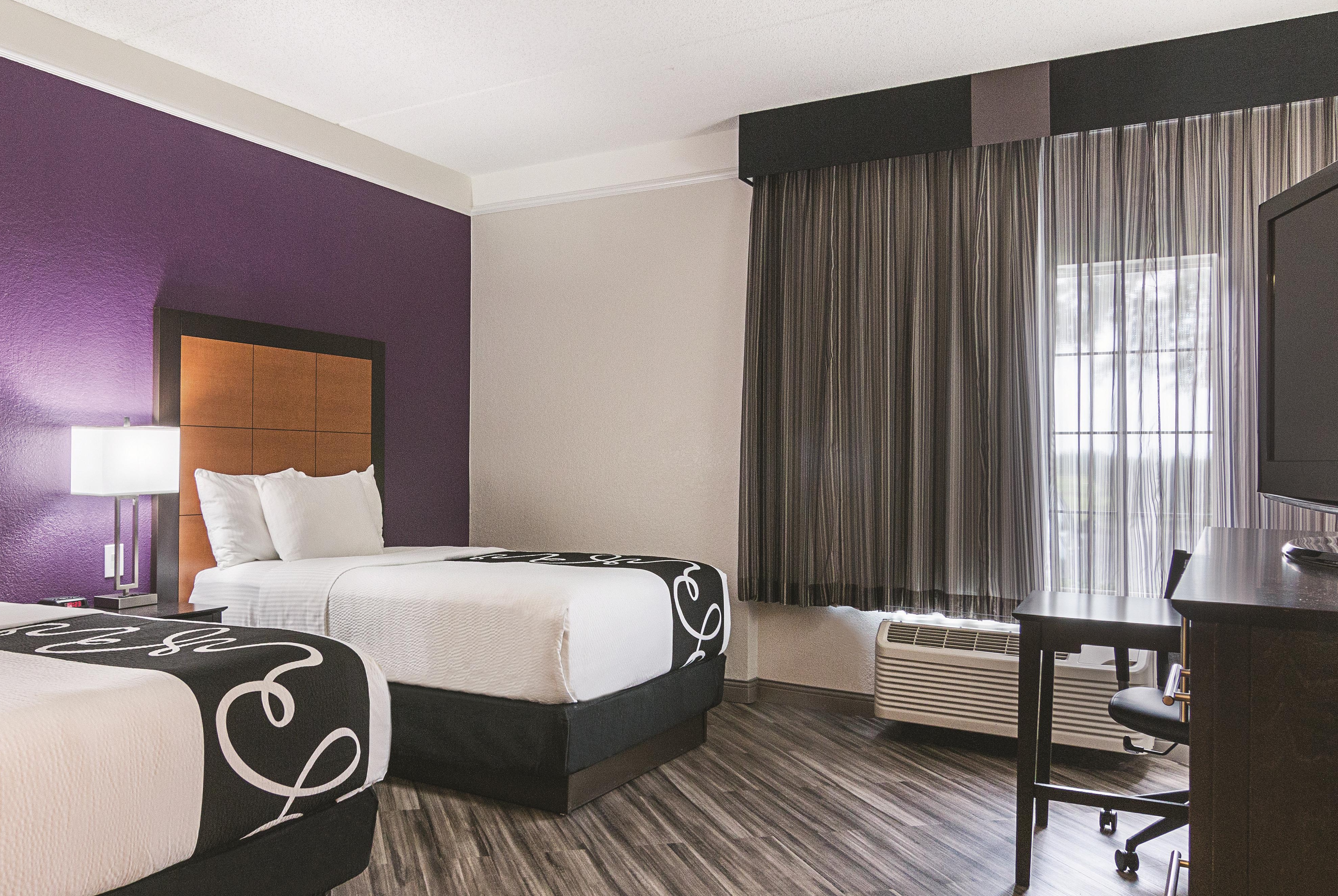 Guest room at the La Quinta Inn & Suites by Wyndham Orlando Airport in Orlando, Florida