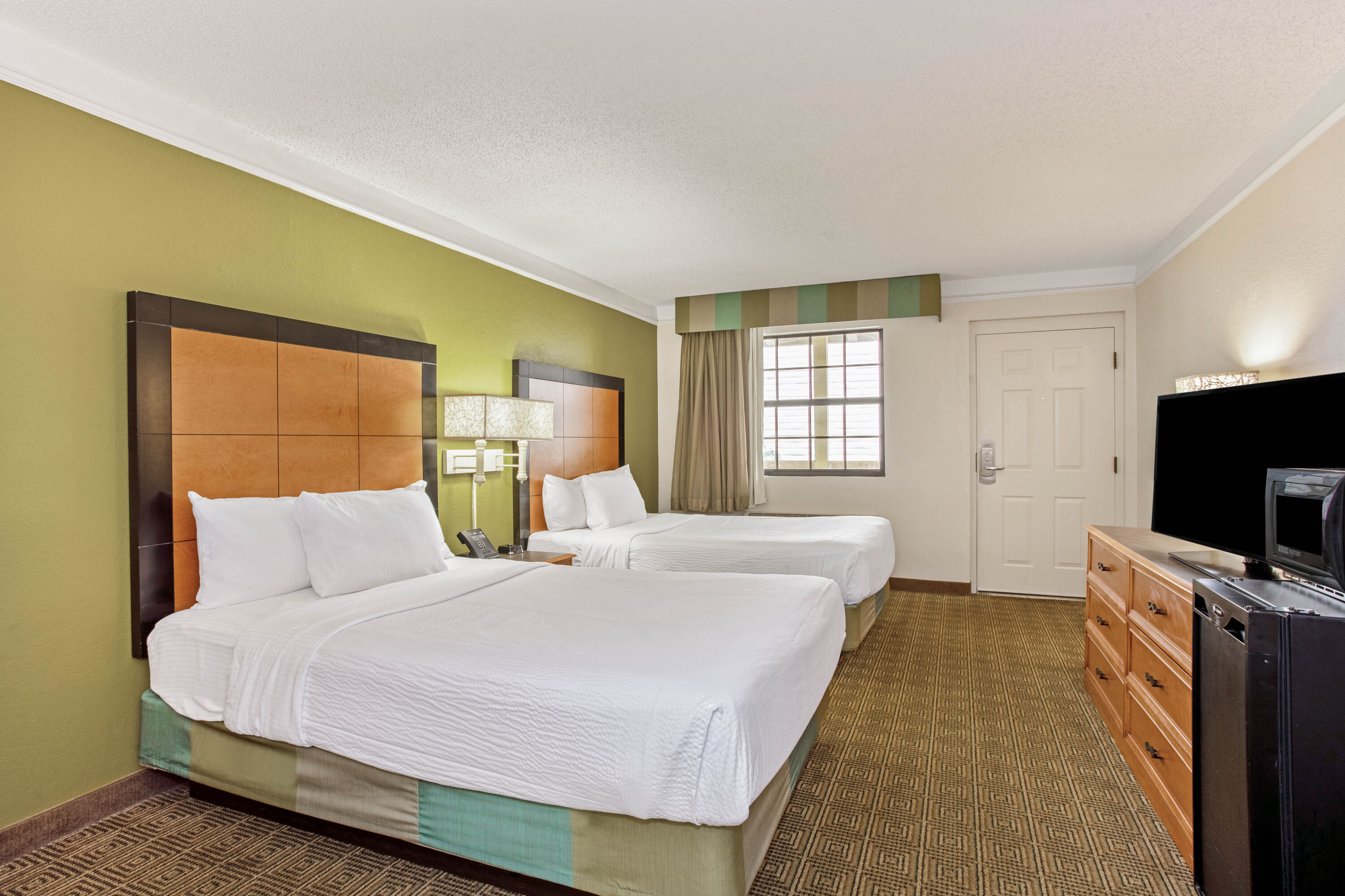 Guest room at the La Quinta Inn by Wyndham Orlando Airport West in Orlando, Florida