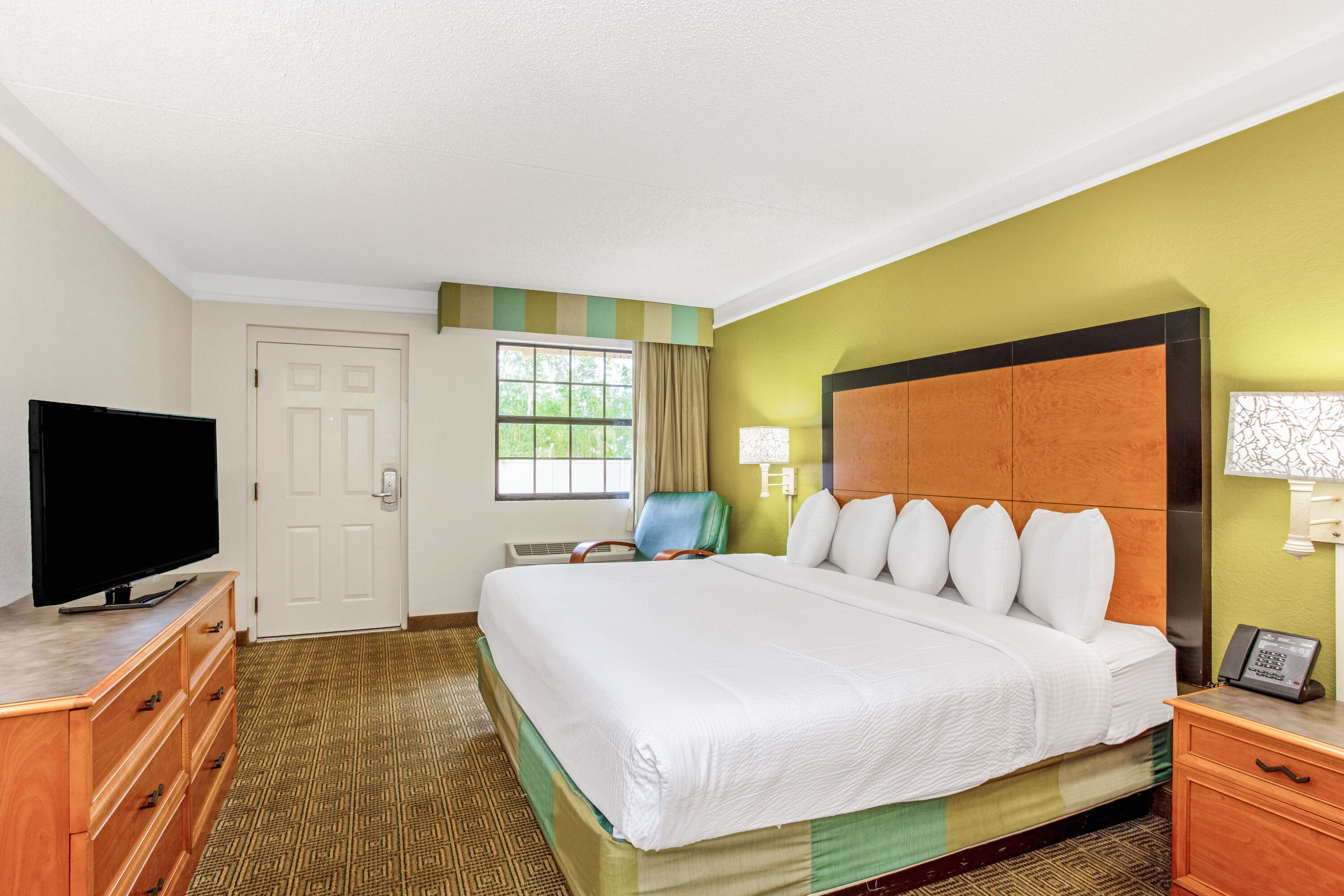 Guest room at the La Quinta Inn by Wyndham Orlando Airport West in Orlando, Florida