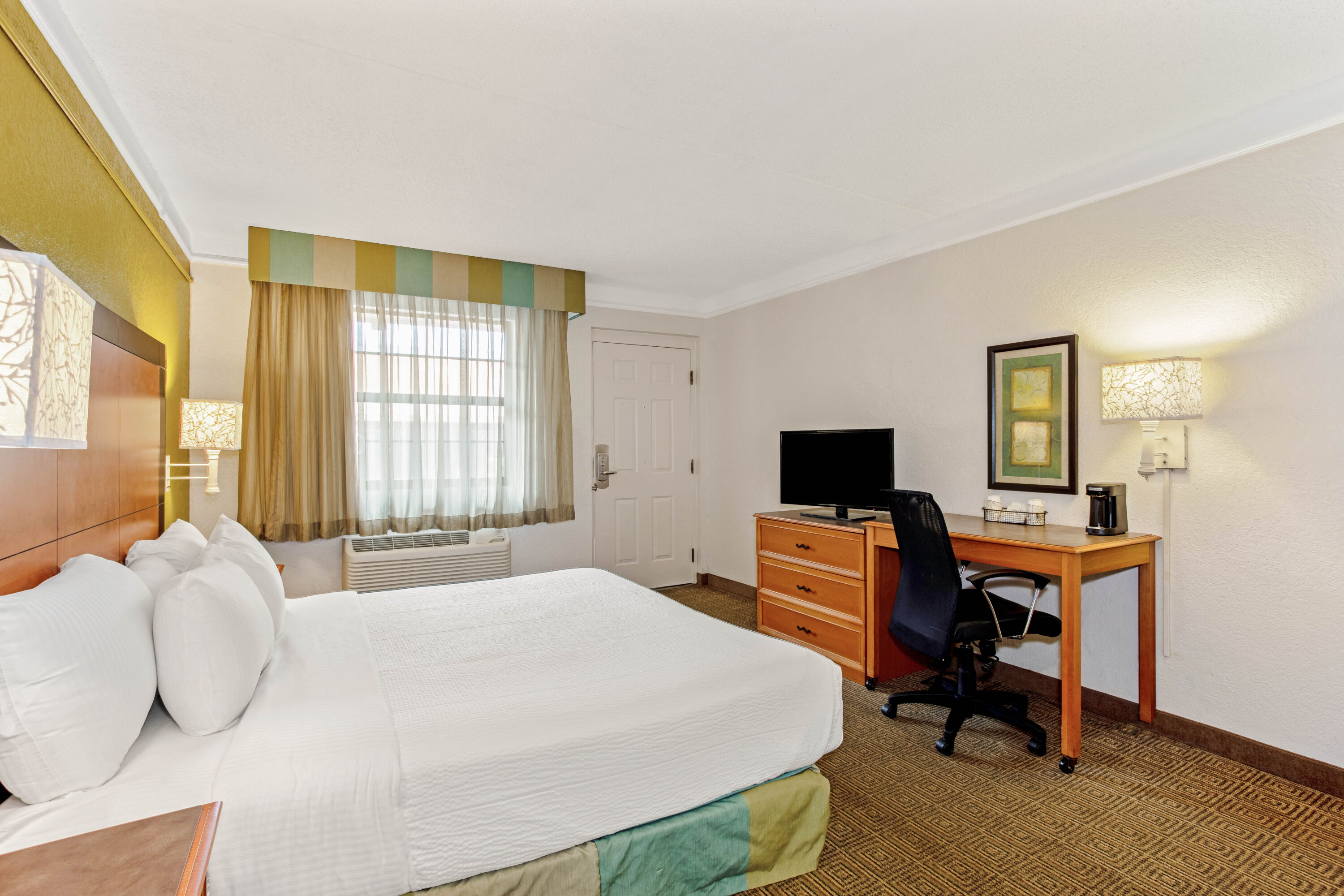 Guest room at the La Quinta Inn by Wyndham Orlando Airport West in Orlando, Florida