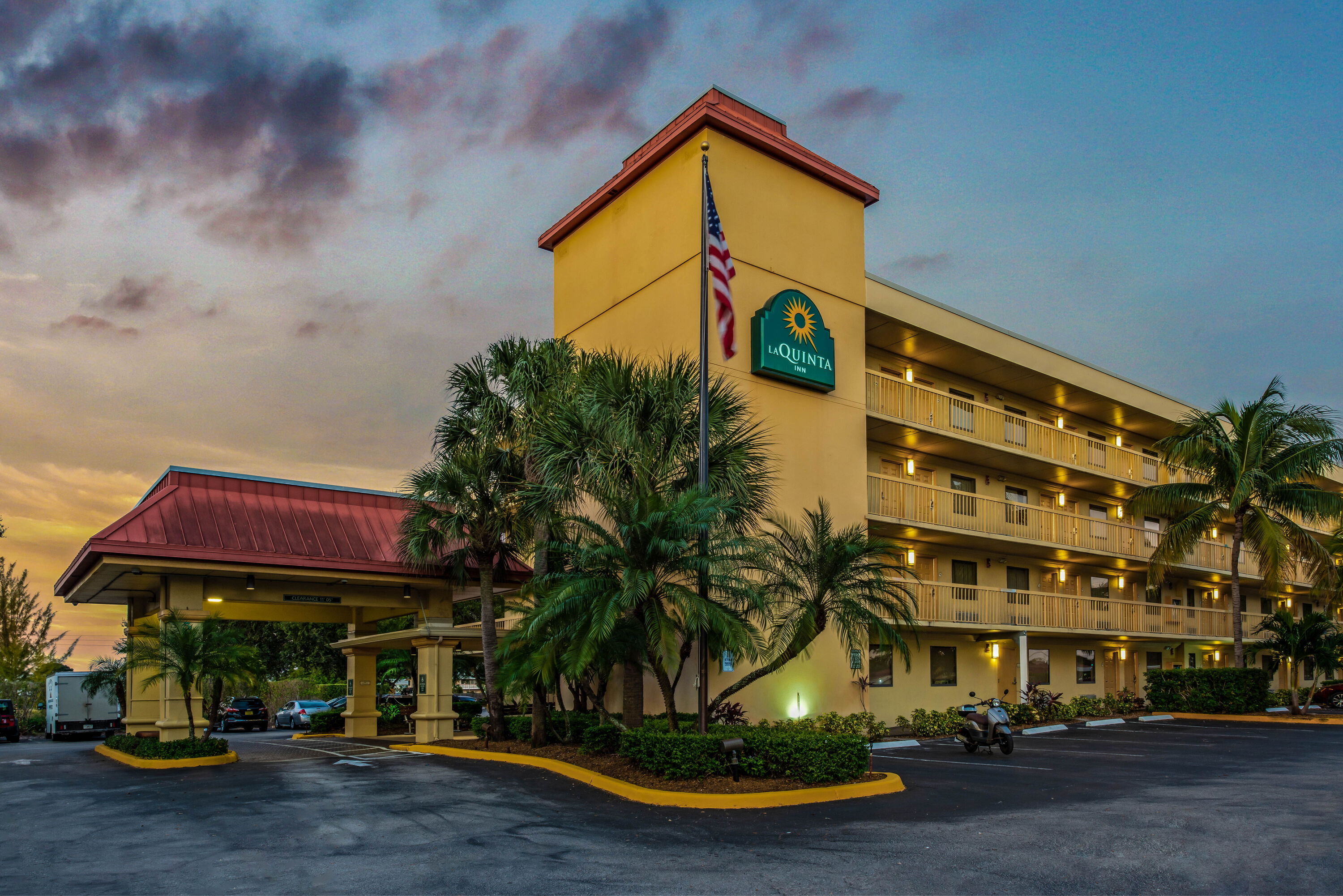 Exterior Dusk Image of La Quinta Inn by Wyndham West Palm Beach - Florida Turnpike hotel in West Palm Beach, Florida