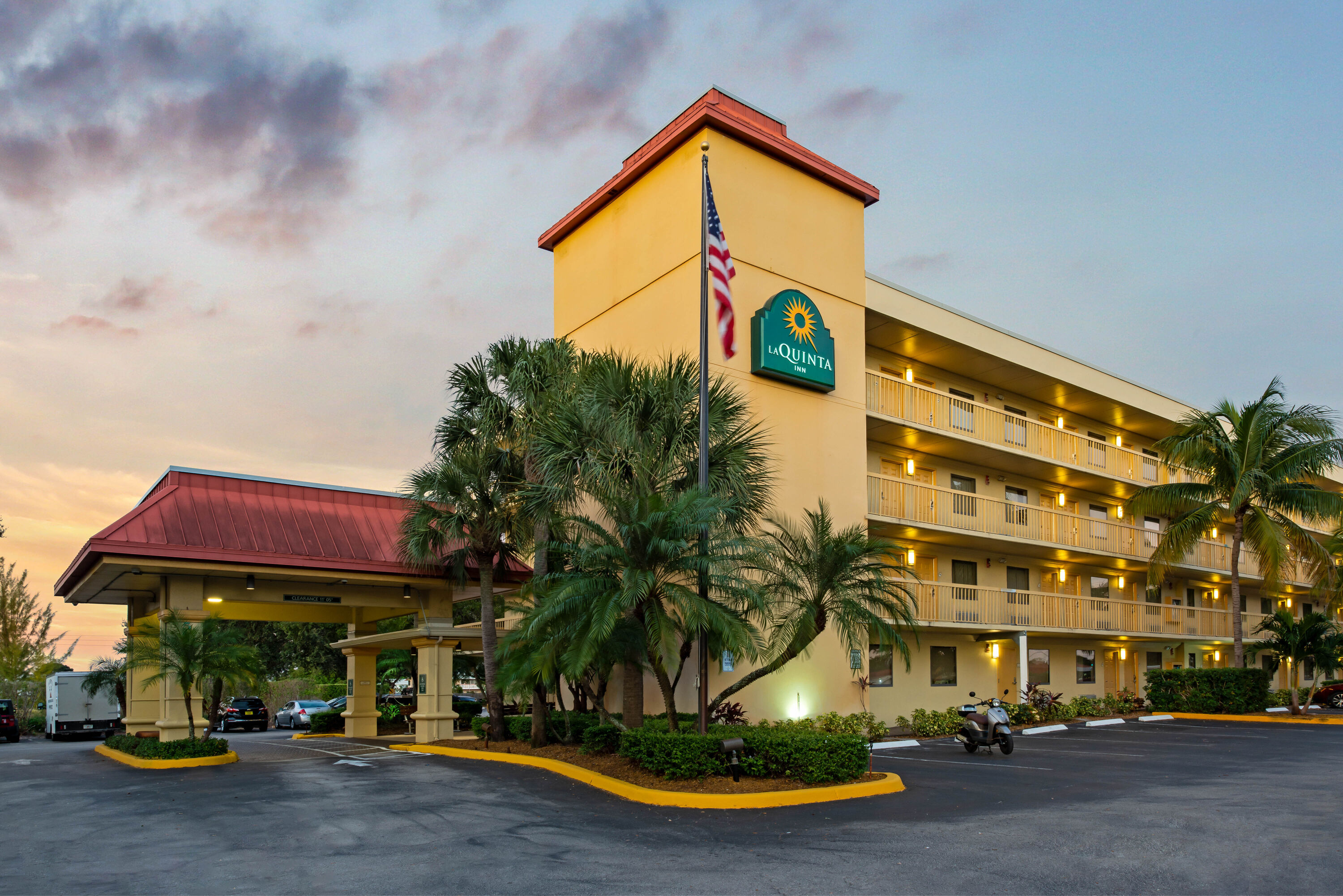 Exterior Dusk Image of La Quinta Inn by Wyndham West Palm Beach - Florida Turnpike hotel in West Palm Beach, Florida